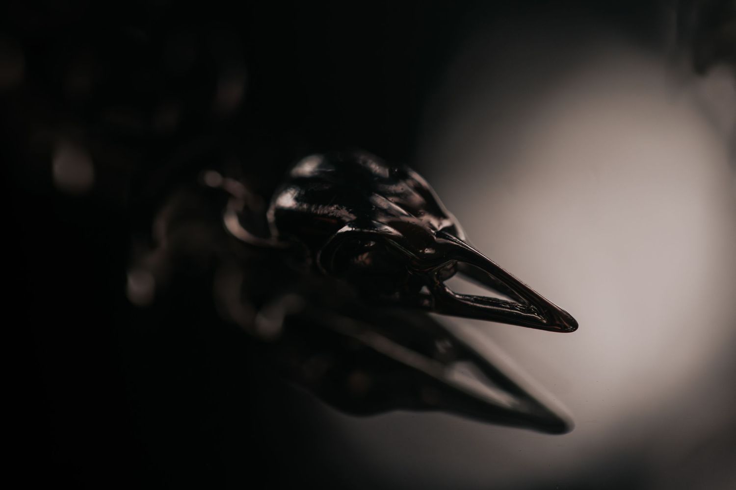 Close-up macro shot of sharp metal spikes or prongs in dark moody lighting.