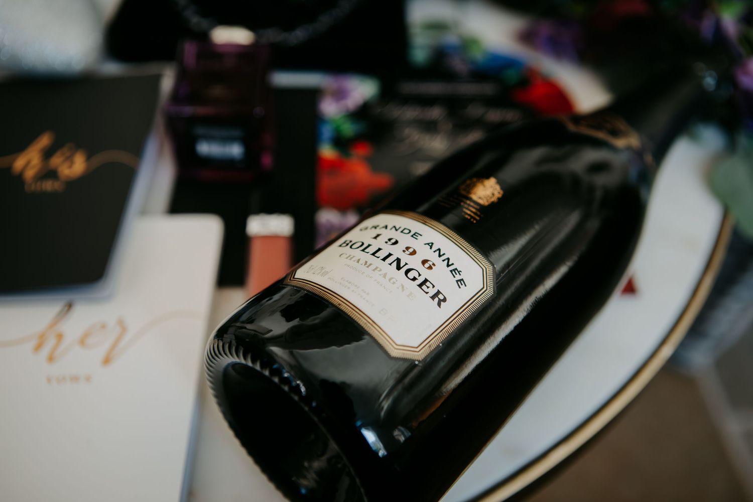 A bottle of Hennessy cognac lying on its side with menu cards visible in the background.
