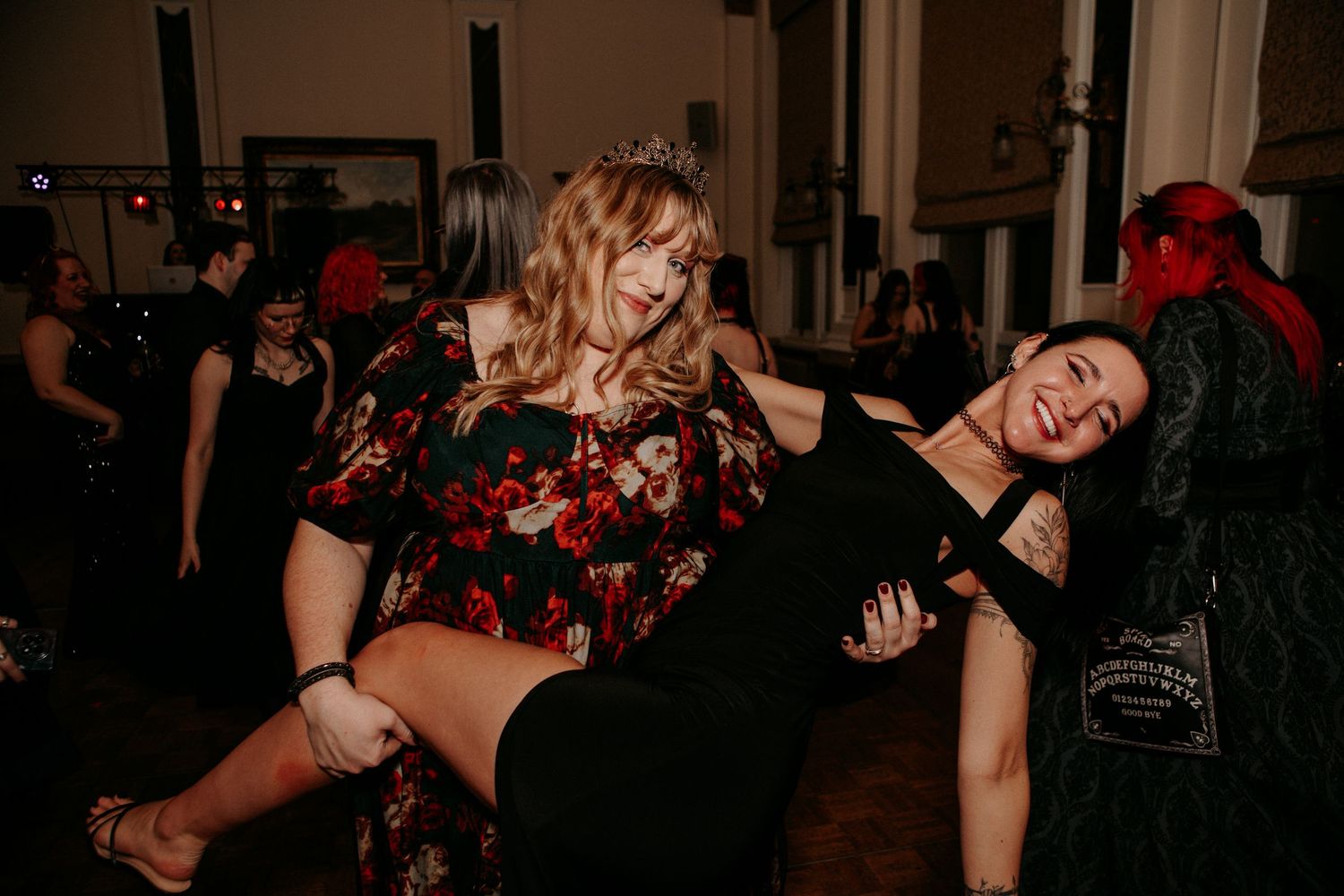 People dancing and posing energetically at what appears to be a lively party or club gathering.