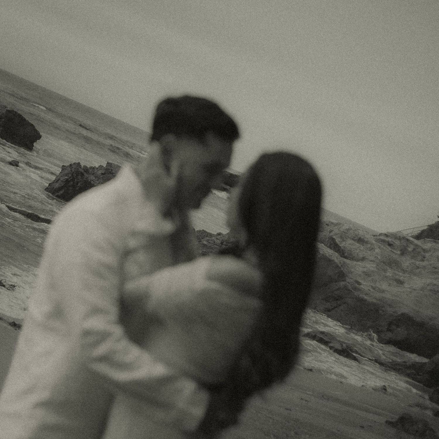 Black and white motion blur photo of couple on Laguna Beach.