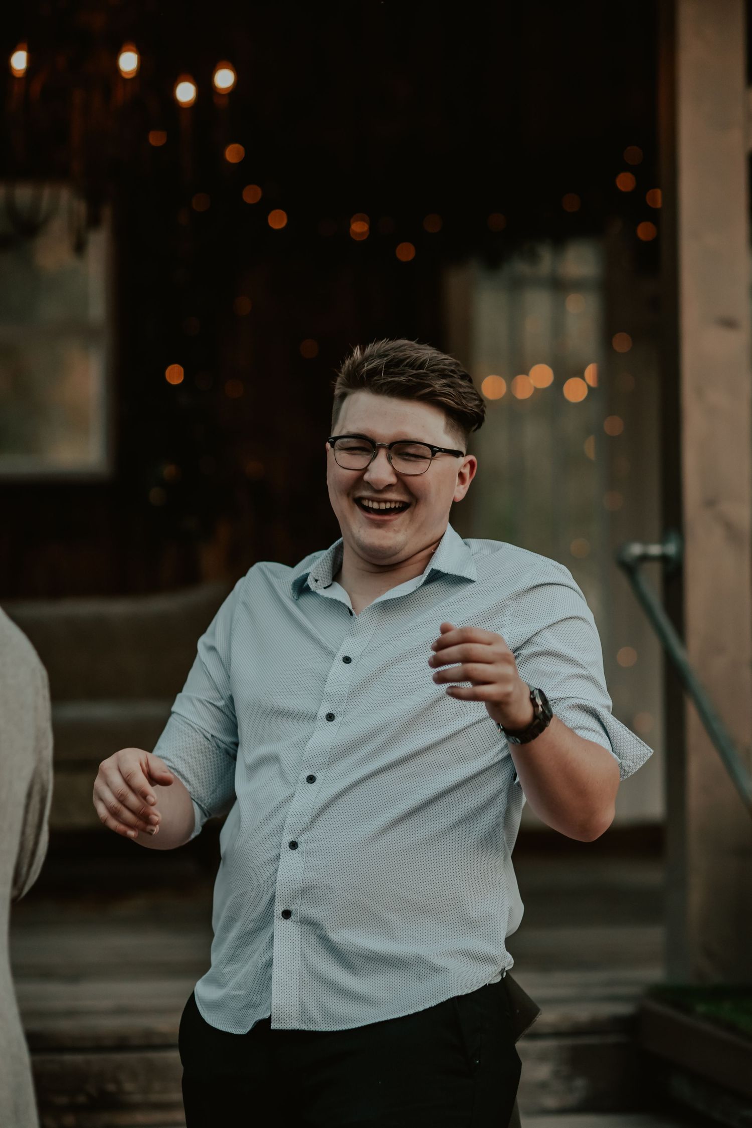 Friend laughing because he accidentally ripped his pants at the wedding