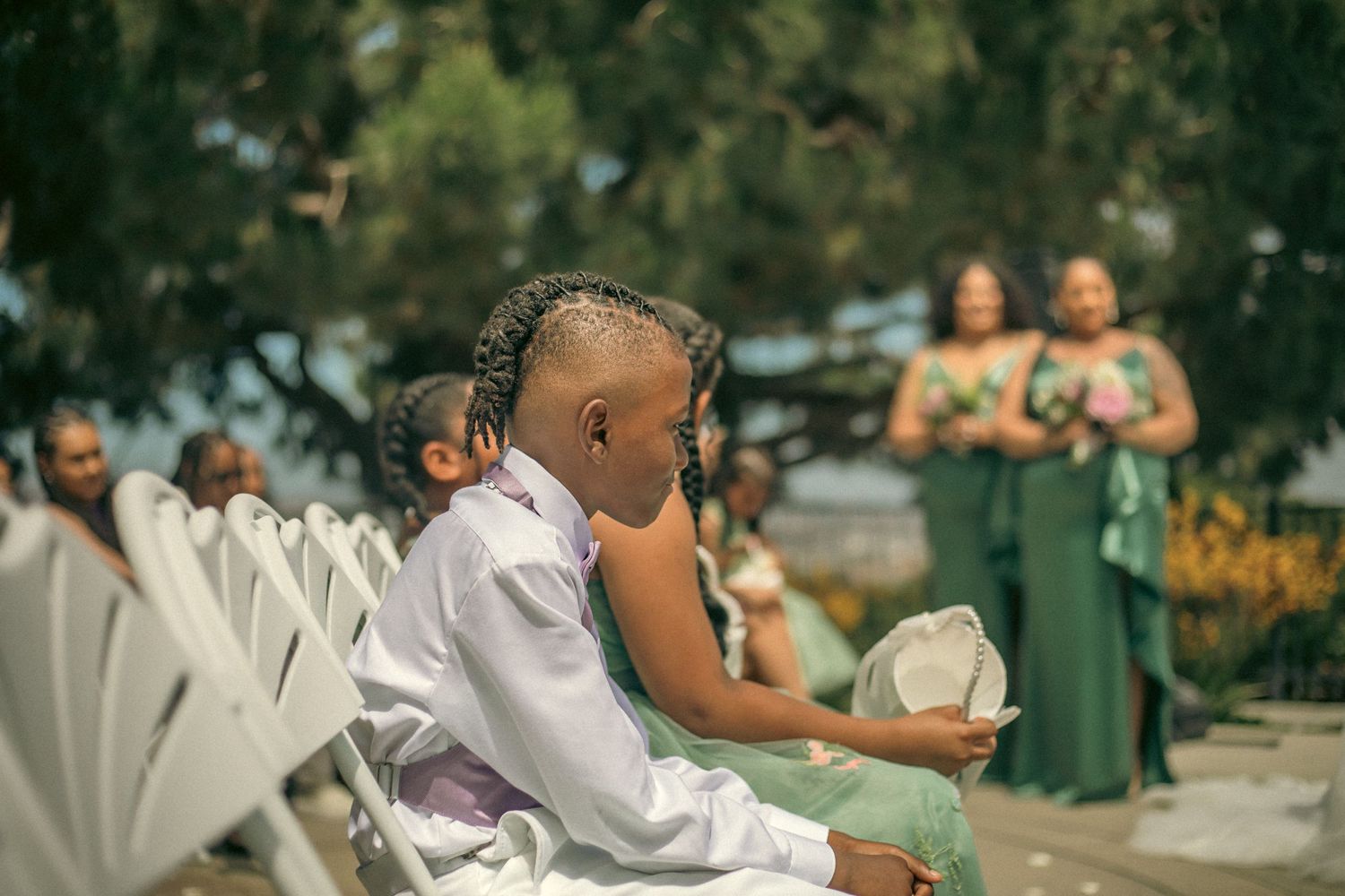 Wedding guests listening to the bride and groom saying their vows