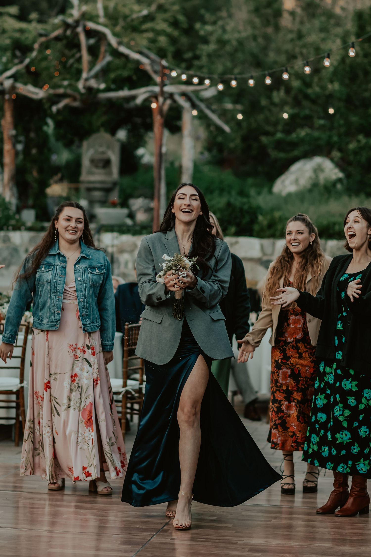 Guest catching the bride's bouquet with excitement