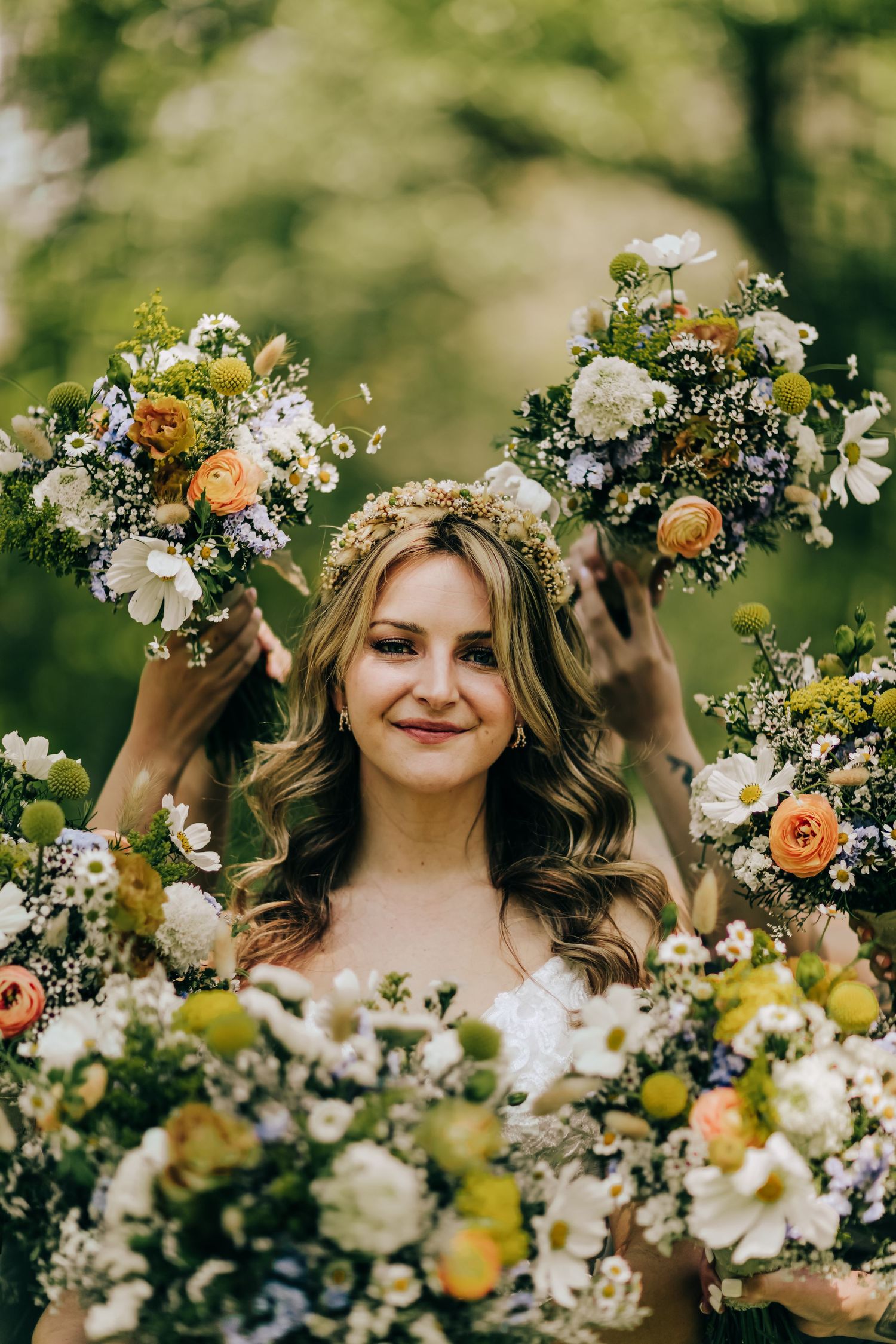 Beautiful floral arrangements featuring white flowers, orange blooms and greenery surrounding the bride