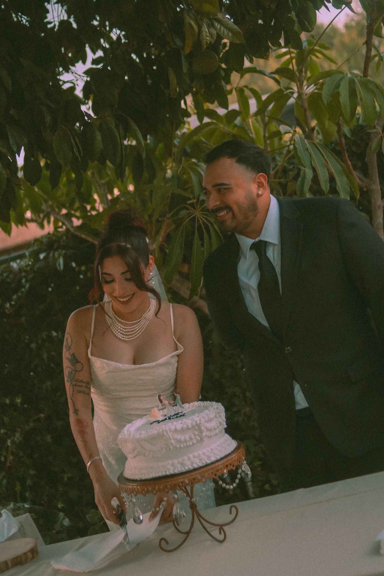 Bride and groom cake cutting after they entered their wedding reception