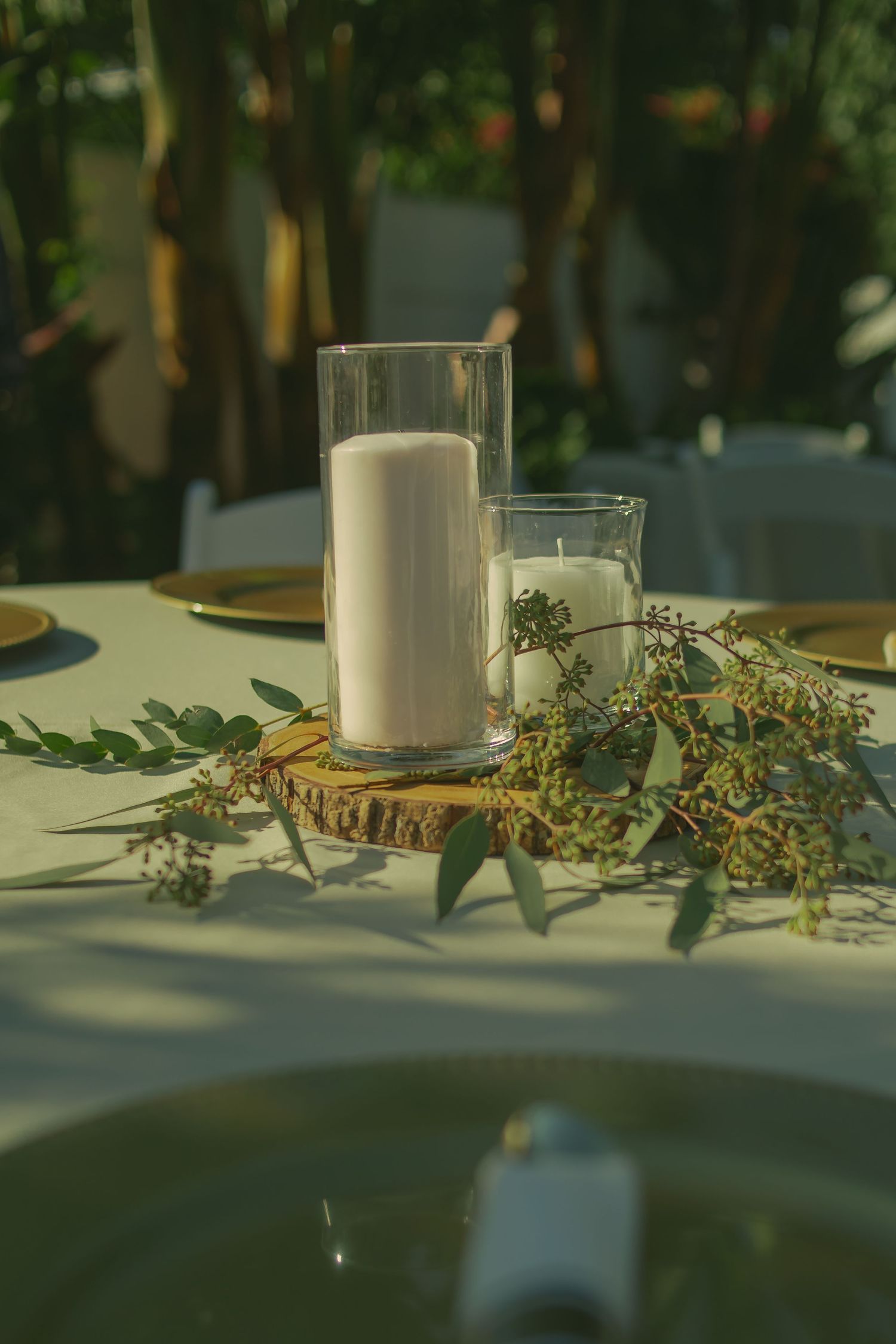 Wedding garden tables with candles and a forest theme.