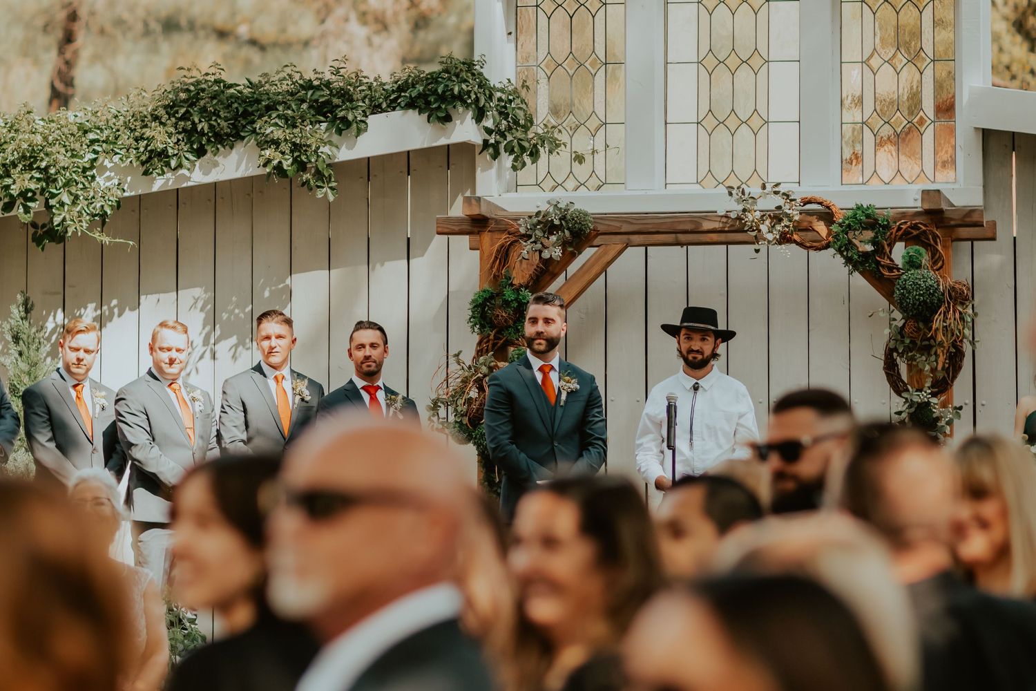 Groom looking beautifully starring at his soon to be bride walking down the aisle