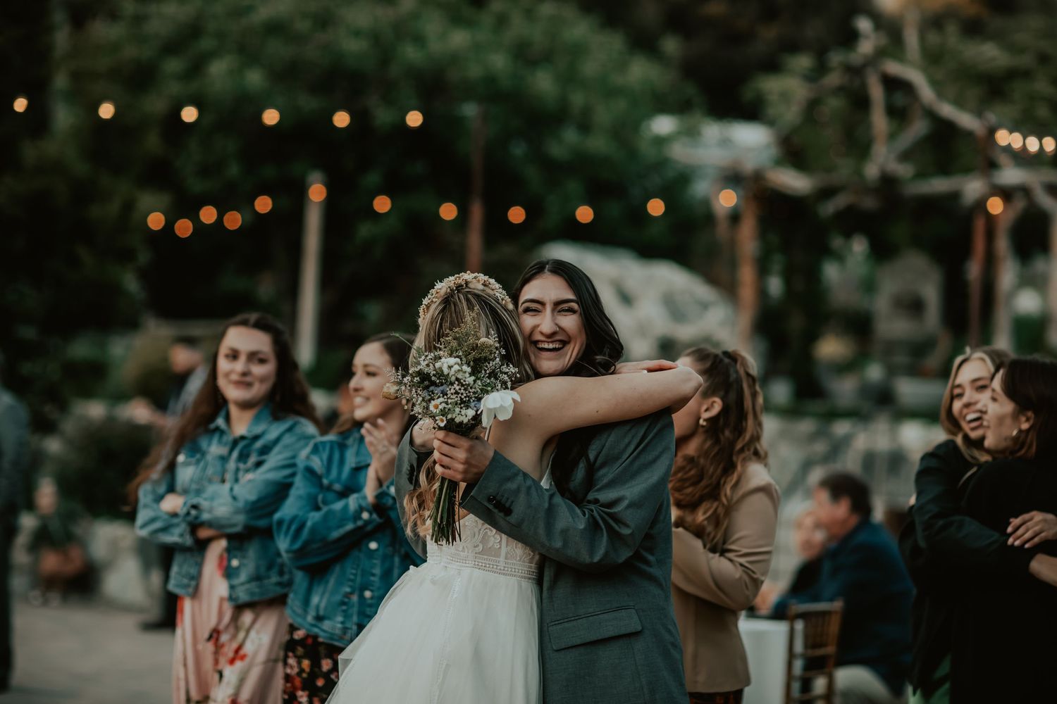 Bride embraces guests as they are both happy and celebrating the catch