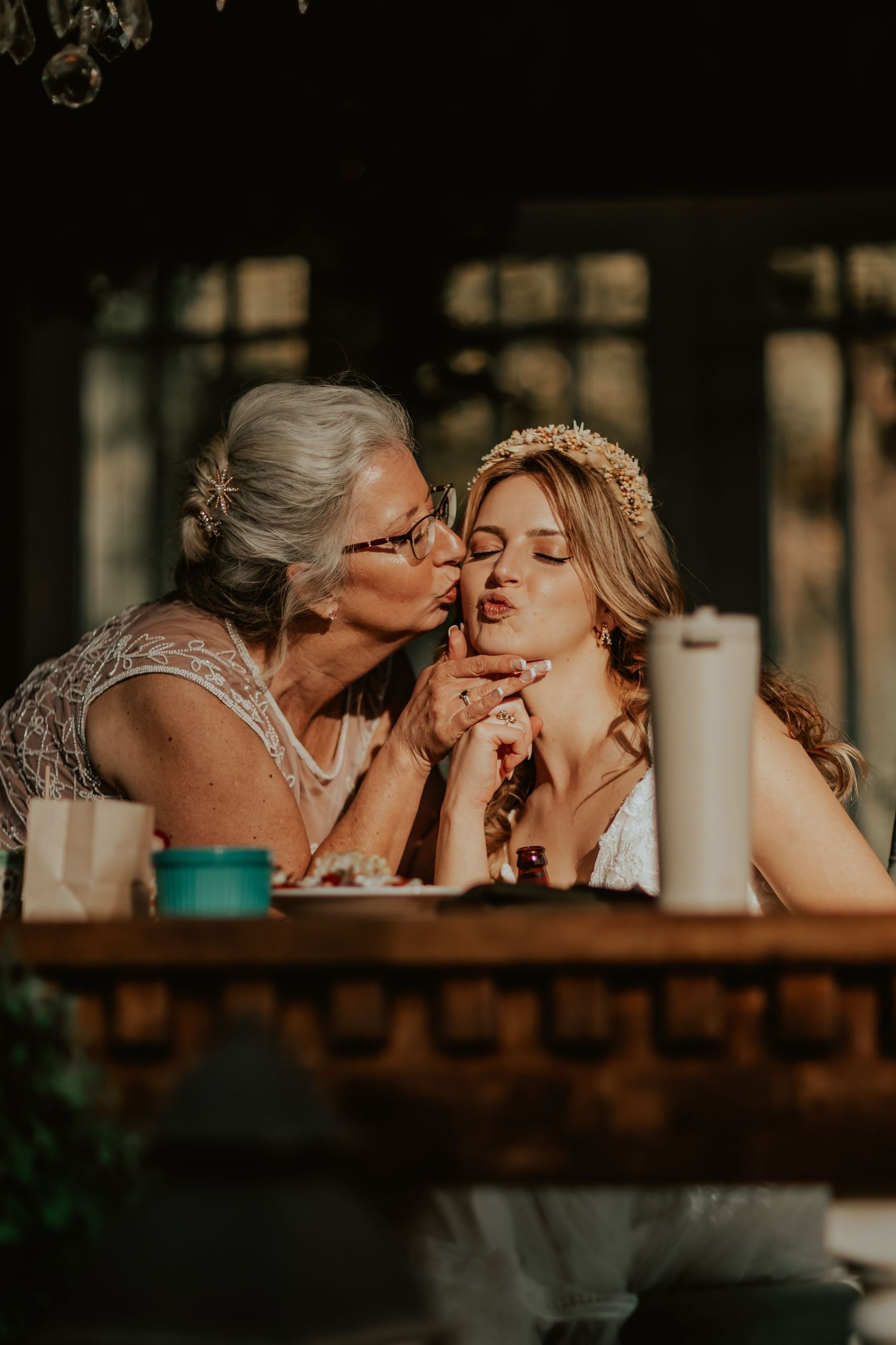 Mother of the bride giving her daughter a loving kiss
