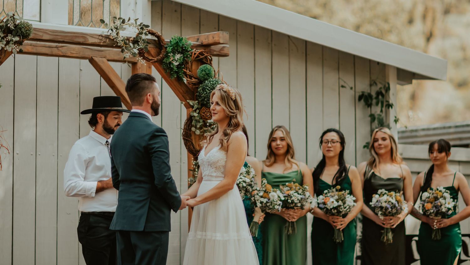 Bride and groom starring into one another eyes as the officiant talks
