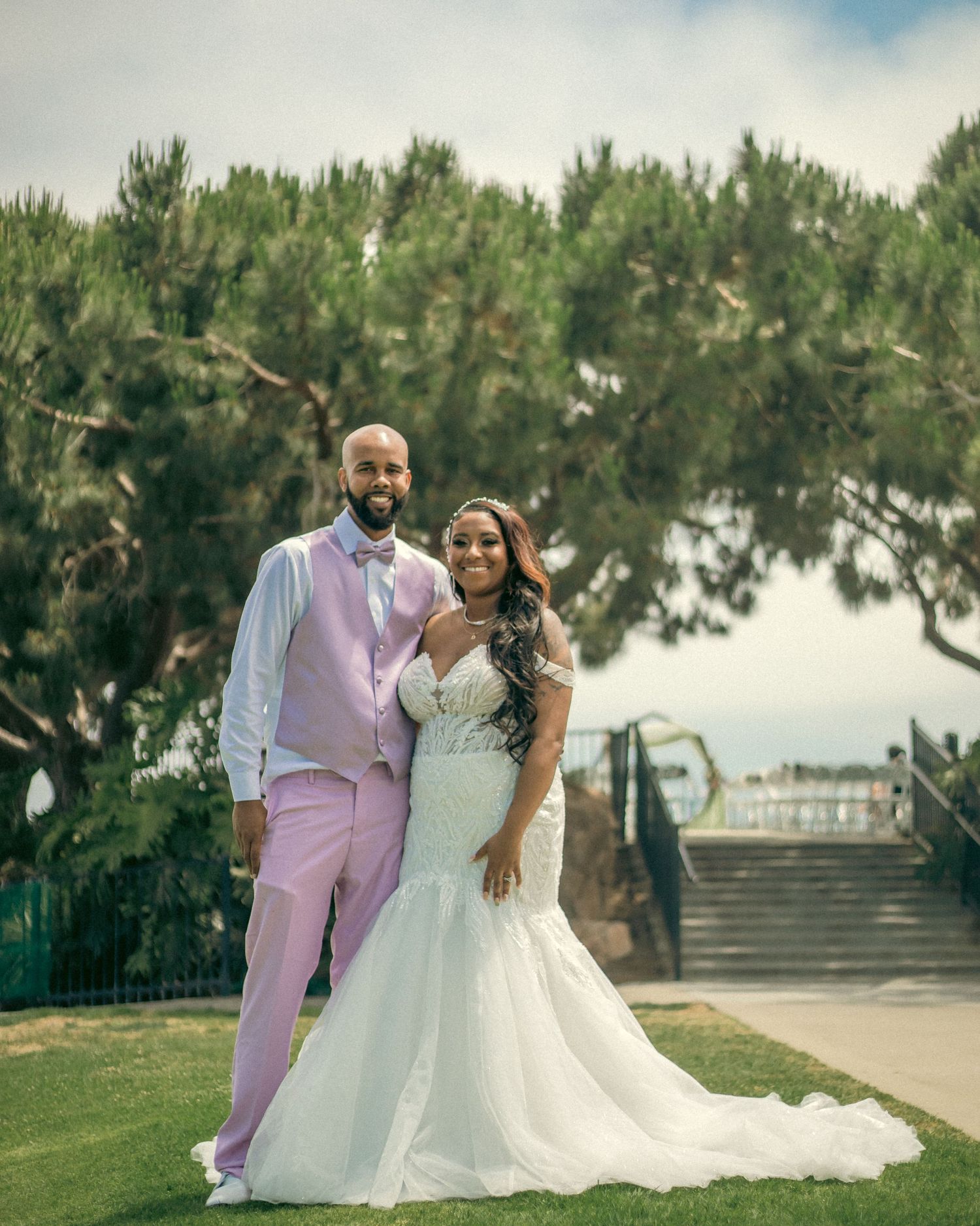 A romantic wedding couple poses outdoors at Heritage Park in Dana Point