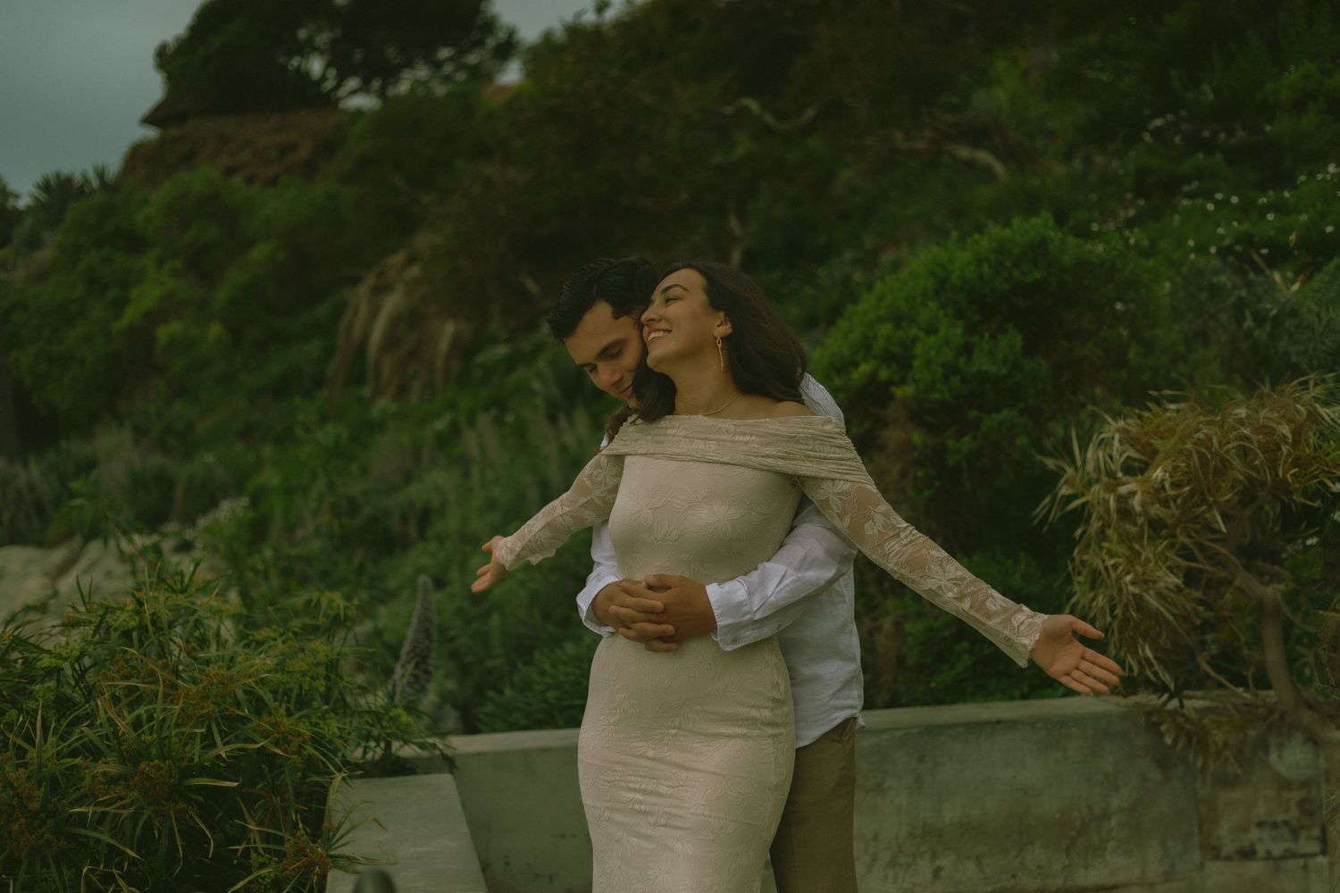Bride and Groom sharing a fun and romantic moment at the beach before their elopement ceremony in Southern California.