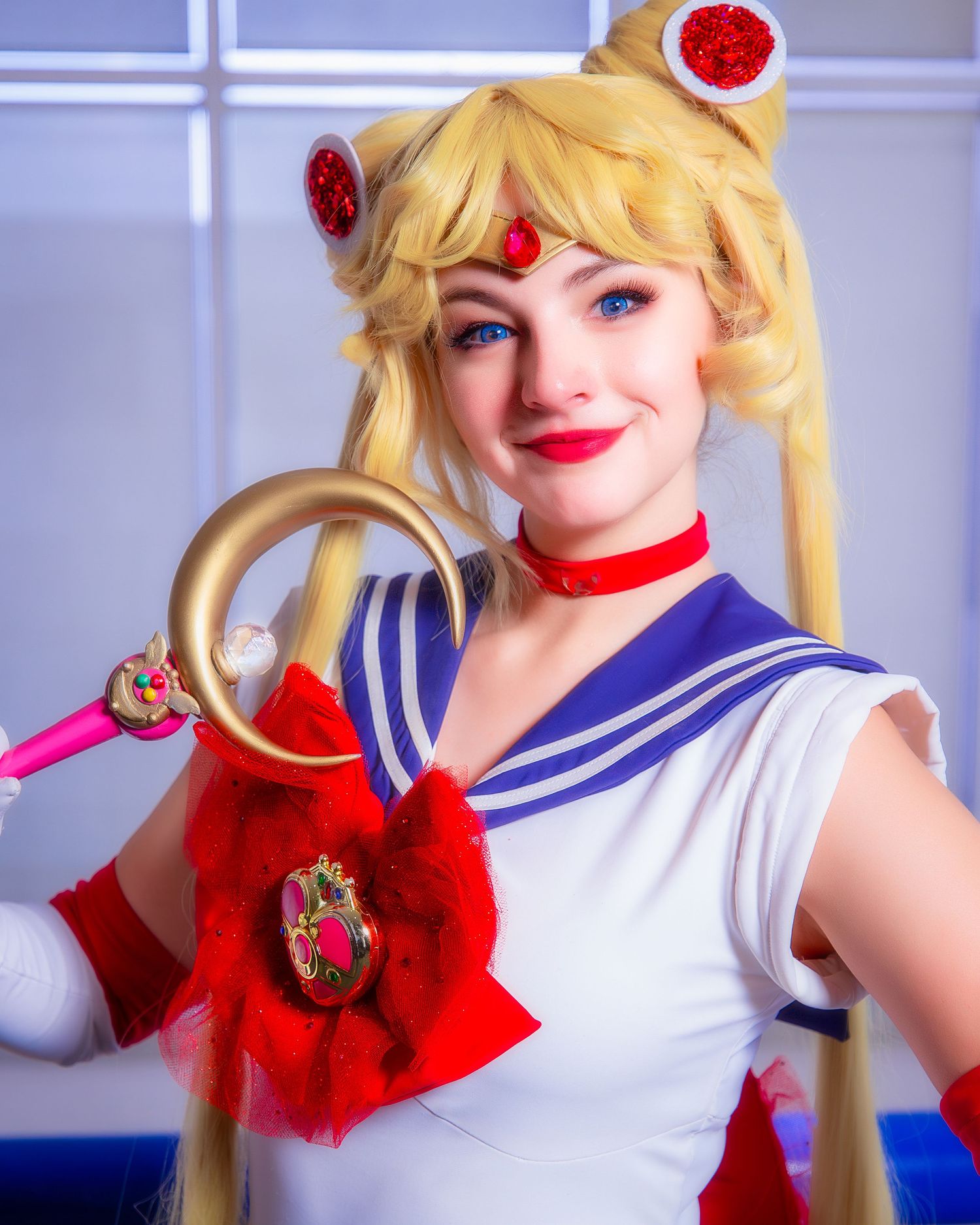 Cosplay costume featuring a sailor-style outfit with blonde pigtails and red accessories.