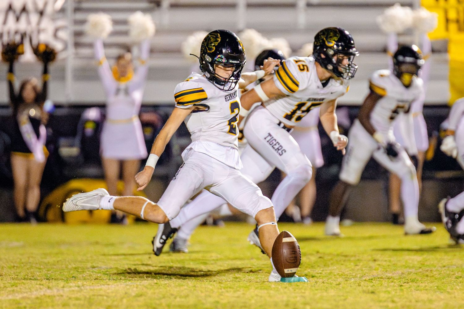 Football players dive and stretch across the field during an intense game sequence.