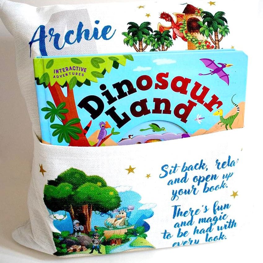 Colorful dinosaur-themed pillow with tropical design and text reading 'Dinosaur Land'.