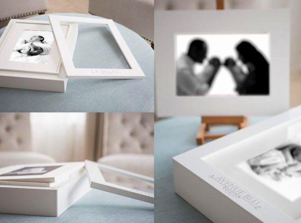 Collection of white photo frames and presentation boxes for professional photography.
