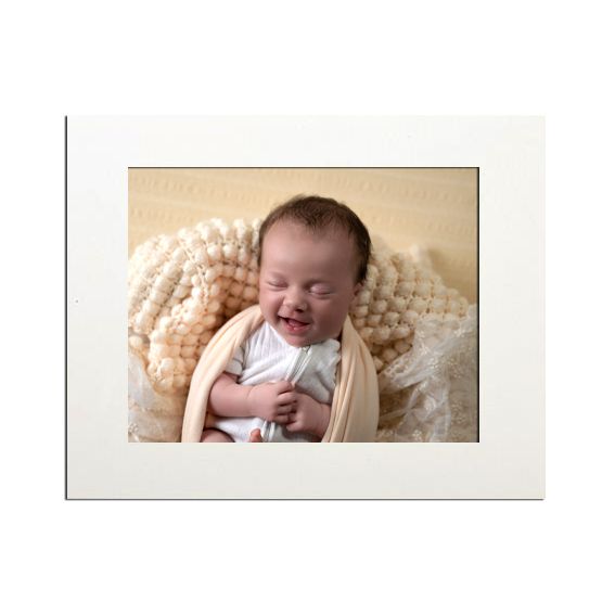 Portrait photograph in white frame with cream-colored knit background.