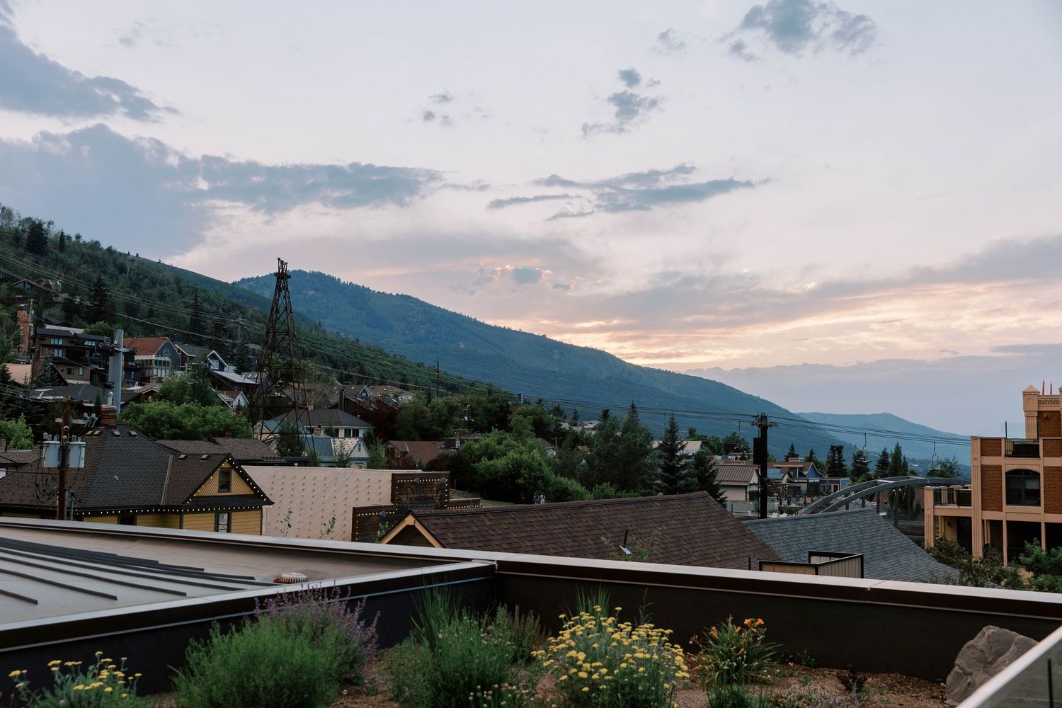 Scenic mountain landscape of park city at sunset with residential buildings nestled on hillside.