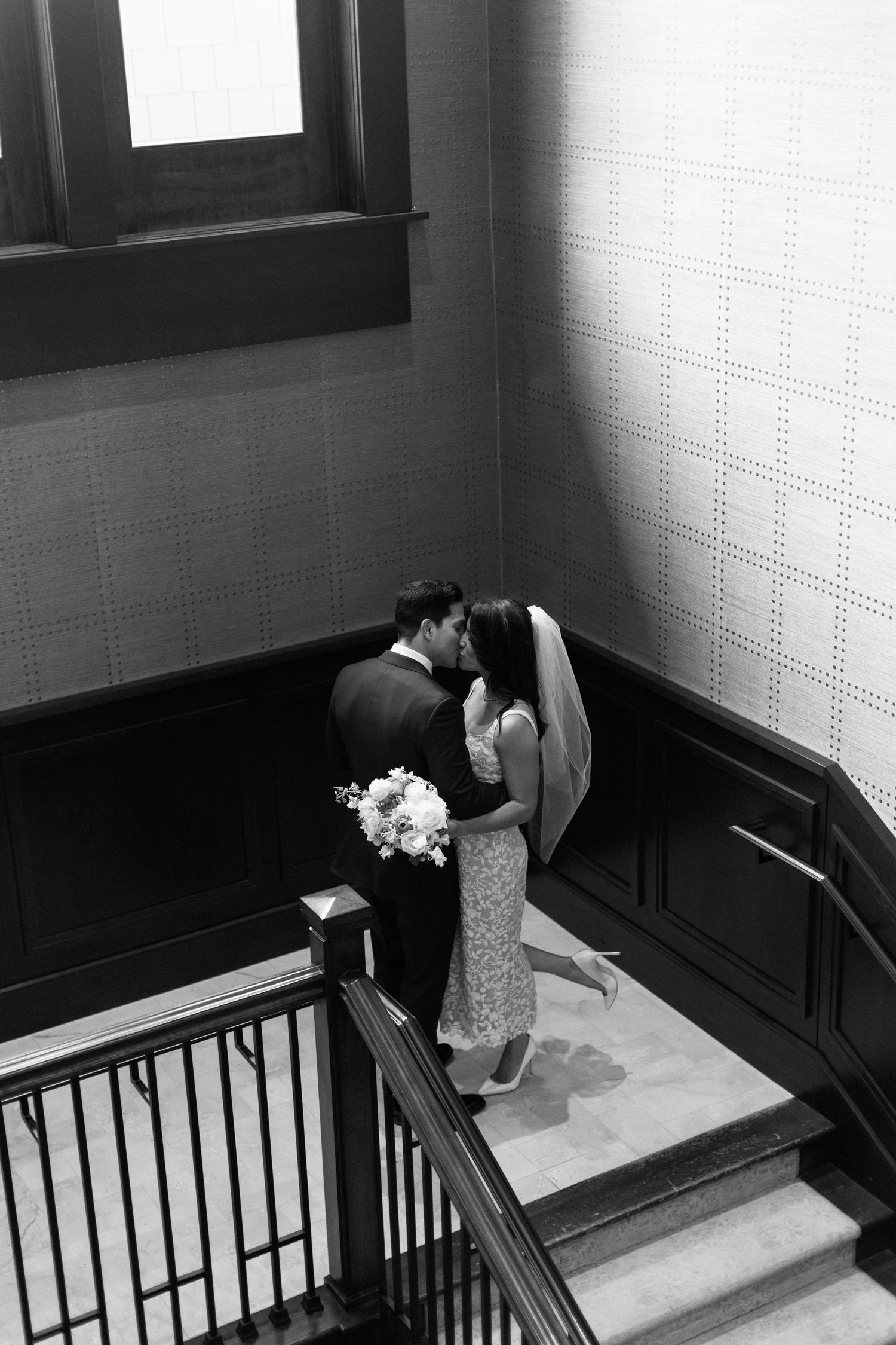 Black and white image capturing an intimate wedding moment on a classic indoor staircase landing at the montage deer valley.