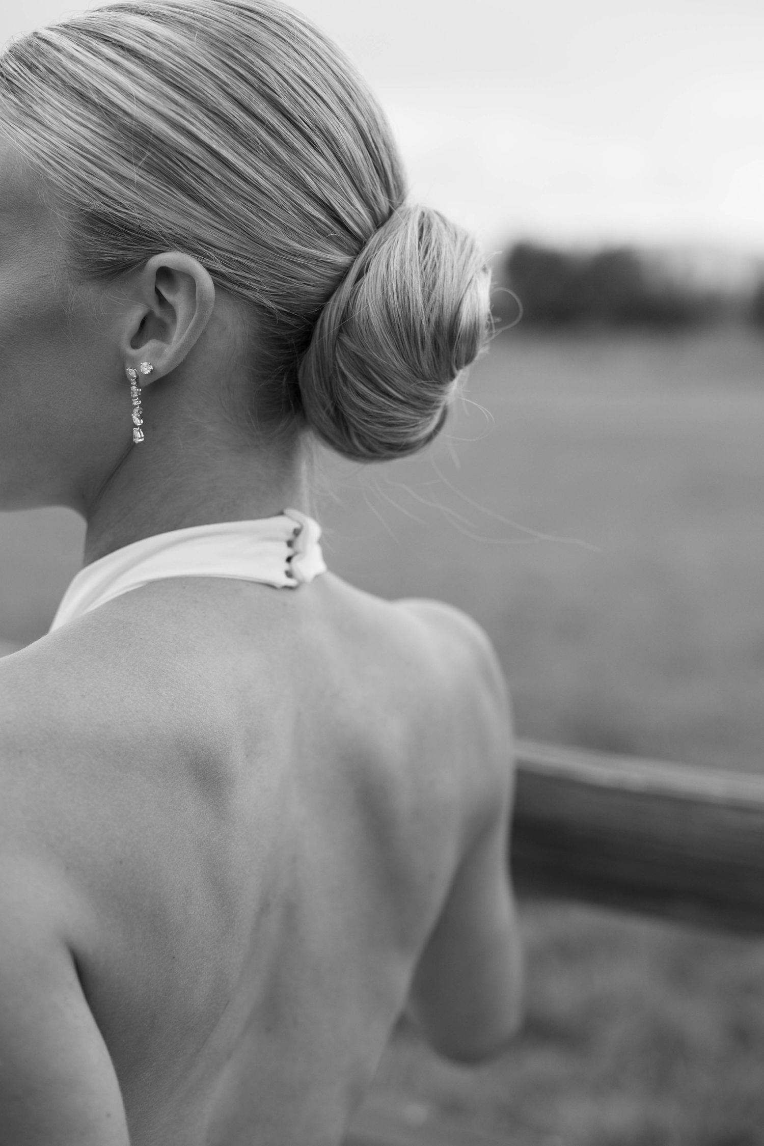 Classic black and white detail of elegant bridal hairstyle and jewelry.