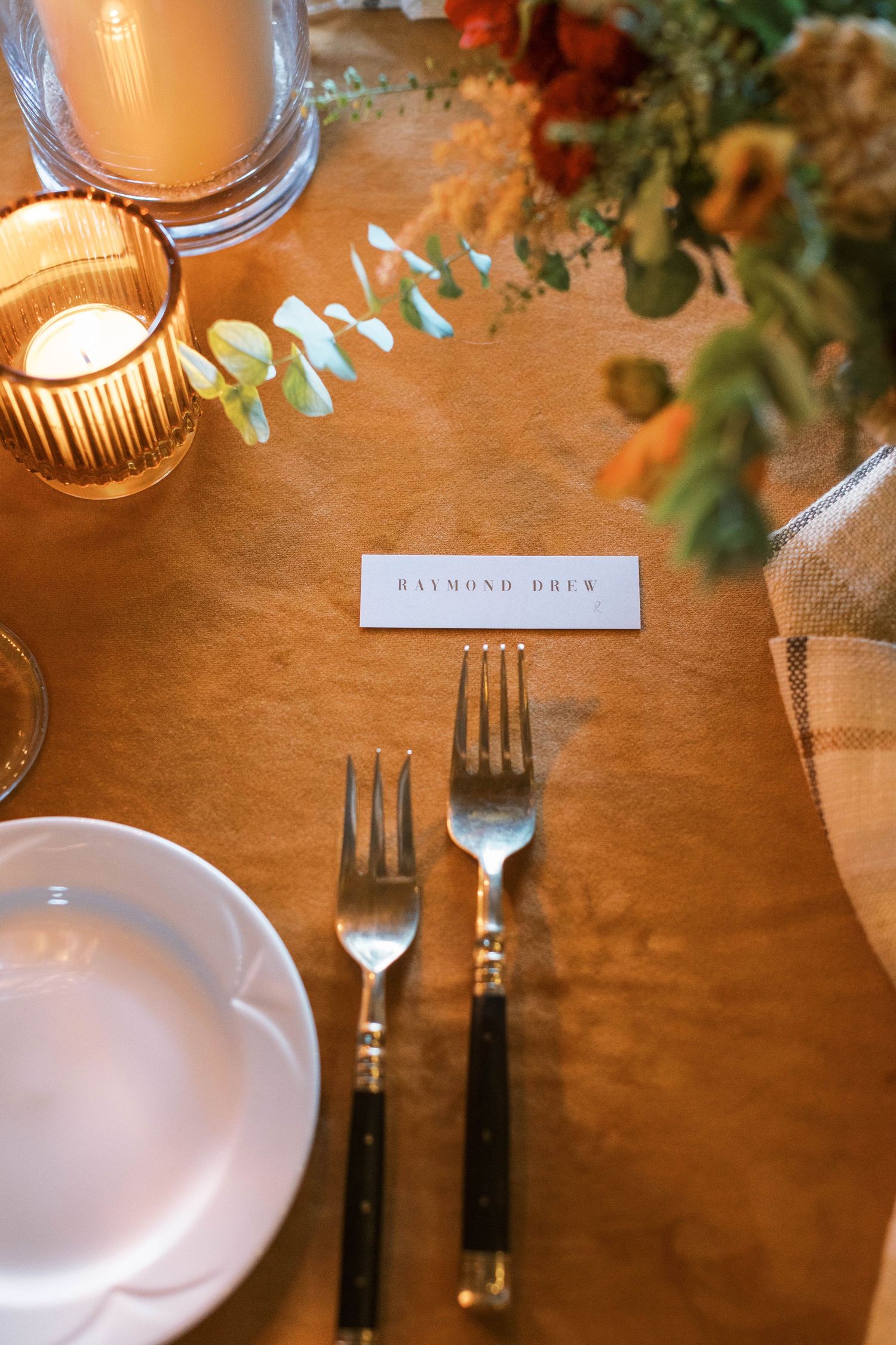 Place setting at wedding reception with menu card and decorative details.
