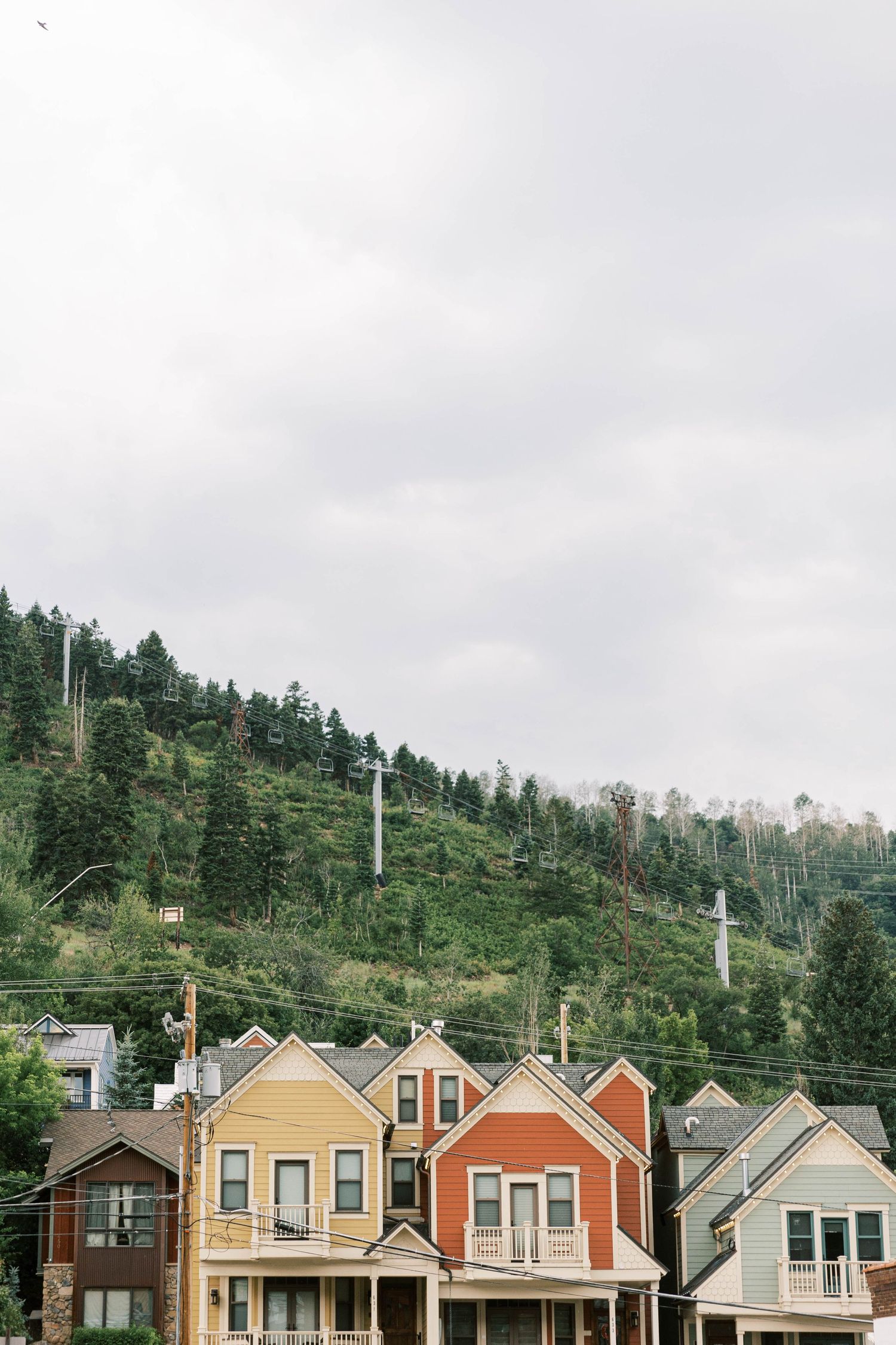 Colorful Park city houses nestled against a forested mountain backdrop.