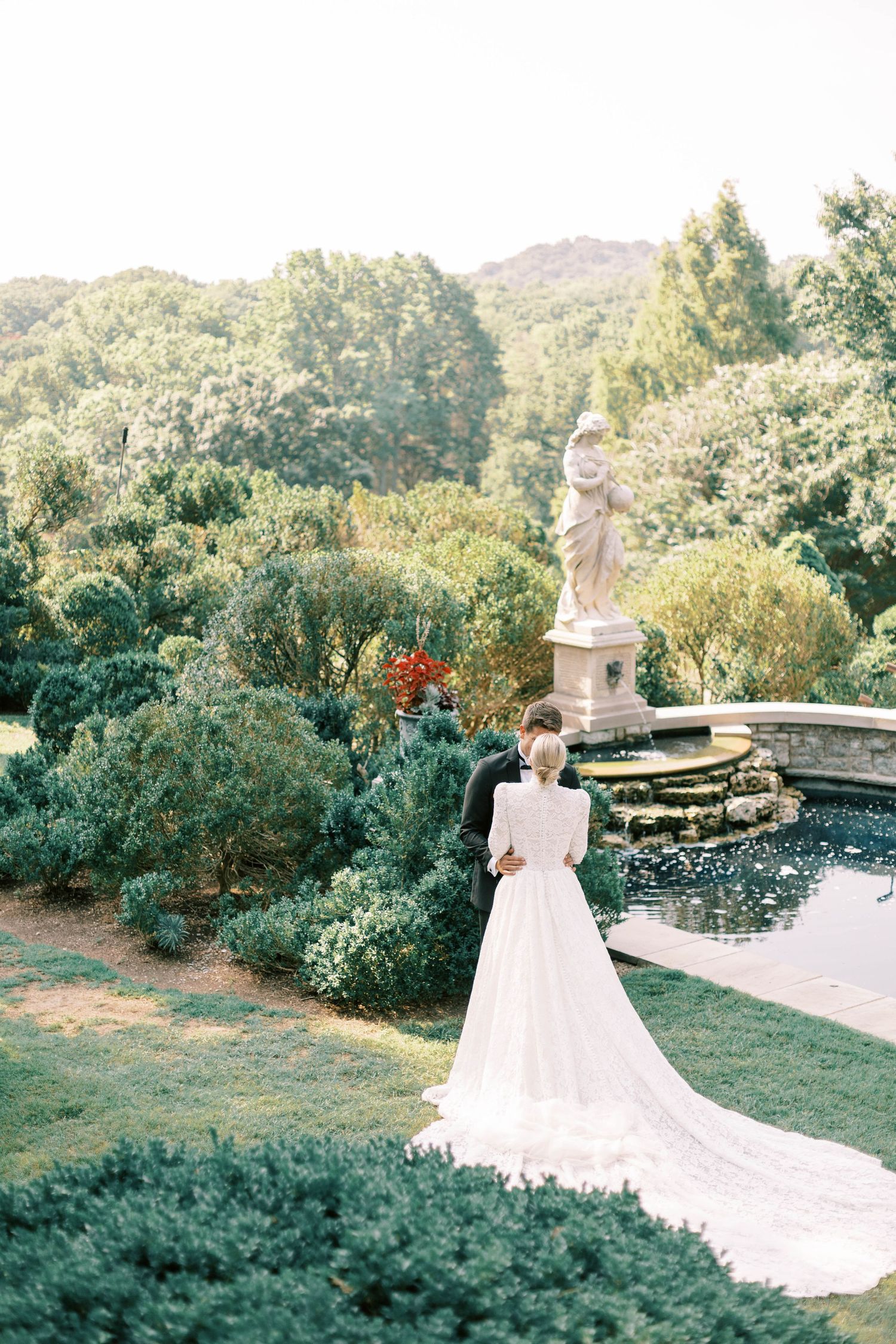 Bridal portrait in a stunning garden landscape with classical statue and reflecting pool of cheekwood estate.