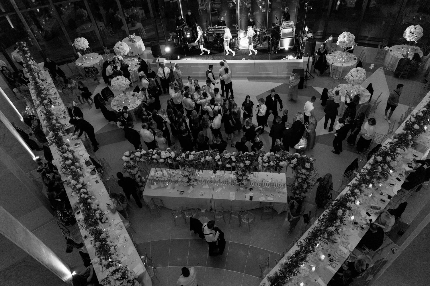 Aerial view of an elegant wedding reception setup with tables and floral arrangements.