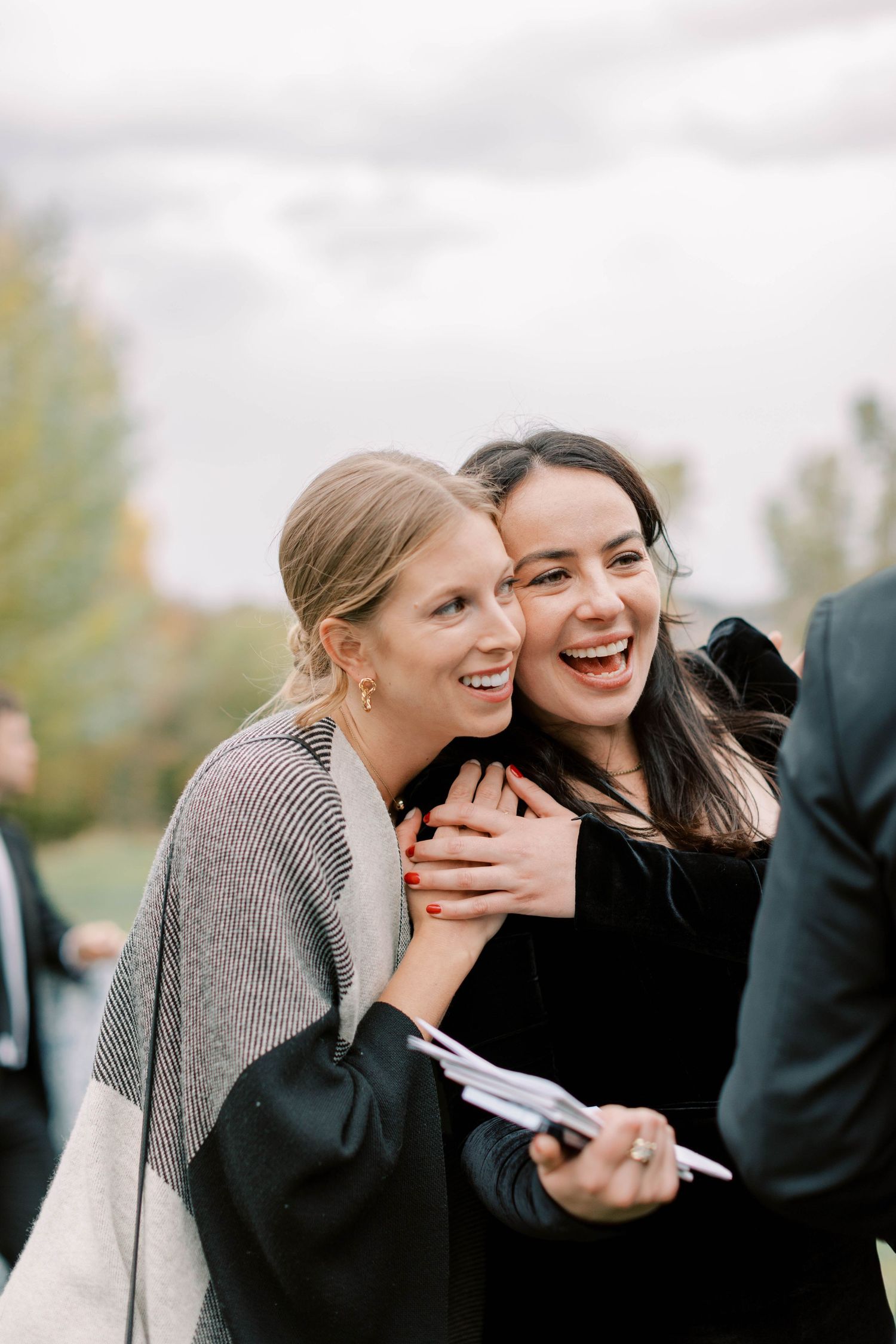 Two guests sharing a joyful moment at an outdoor celebration.