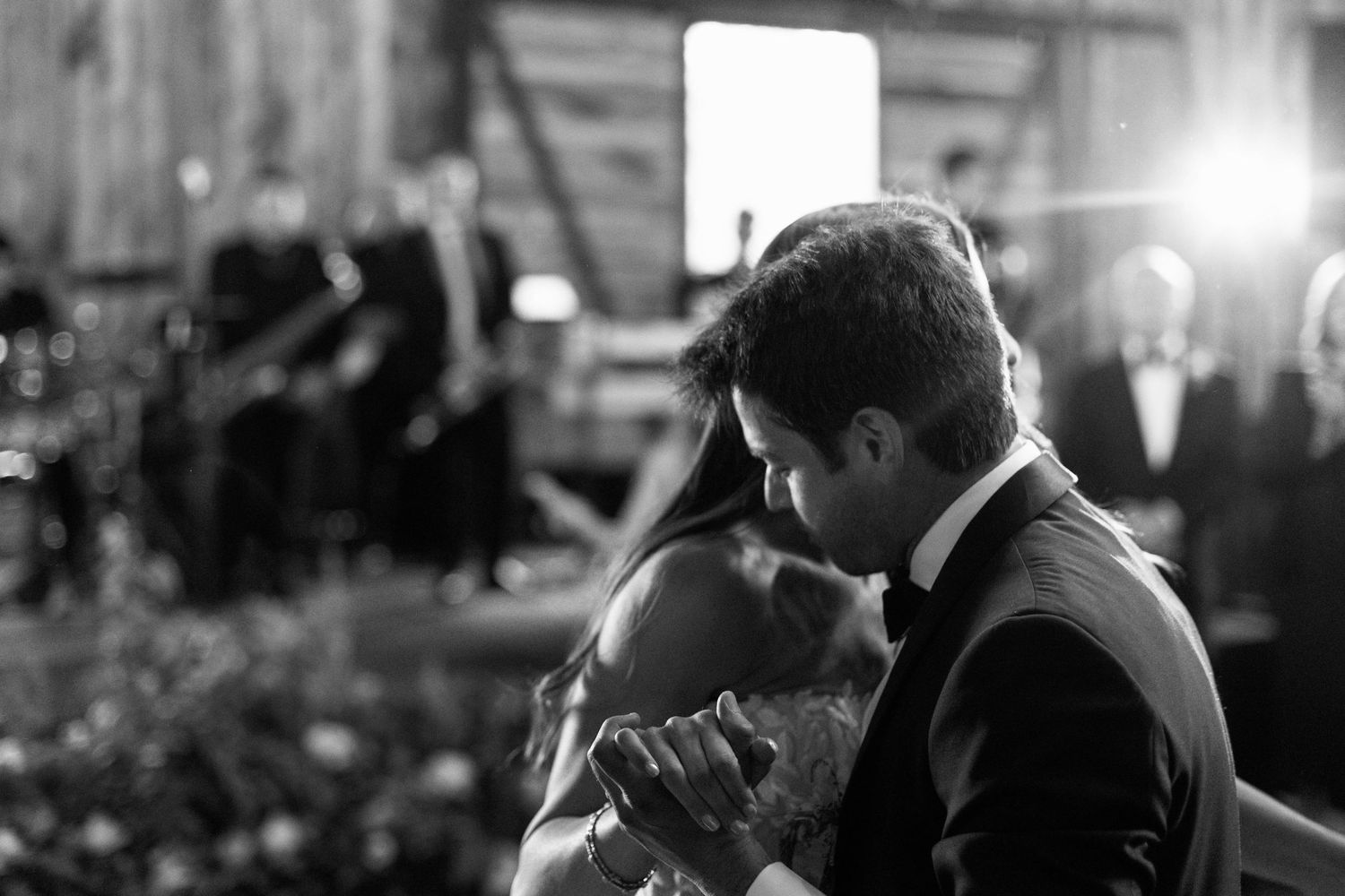 Black and white photo capturing an intimate dance moment at a wedding reception.