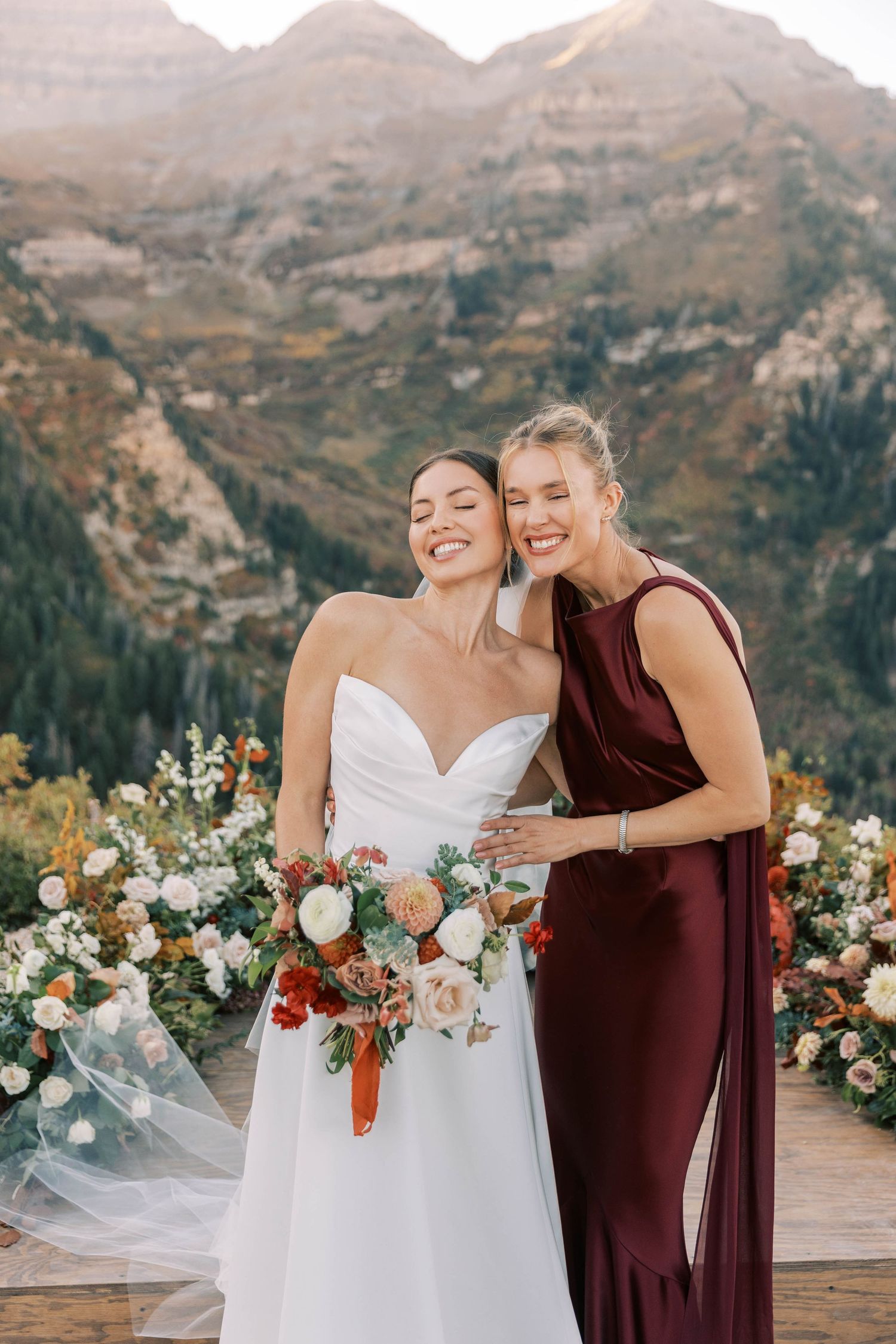 Wedding photo capturing joyful moment against scenic mountain vista.