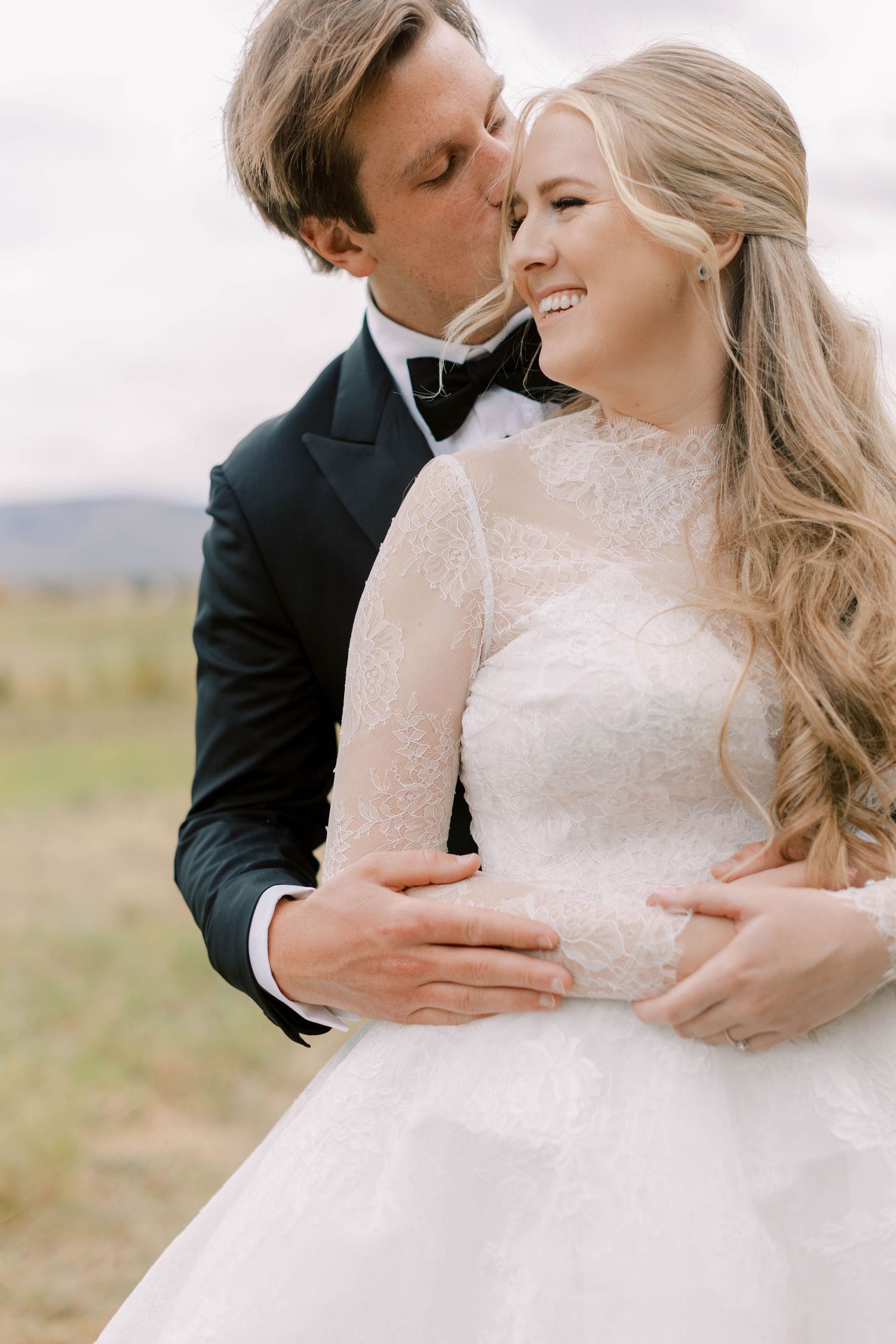 An intimate moment shared between newlyweds in an outdoor setting.