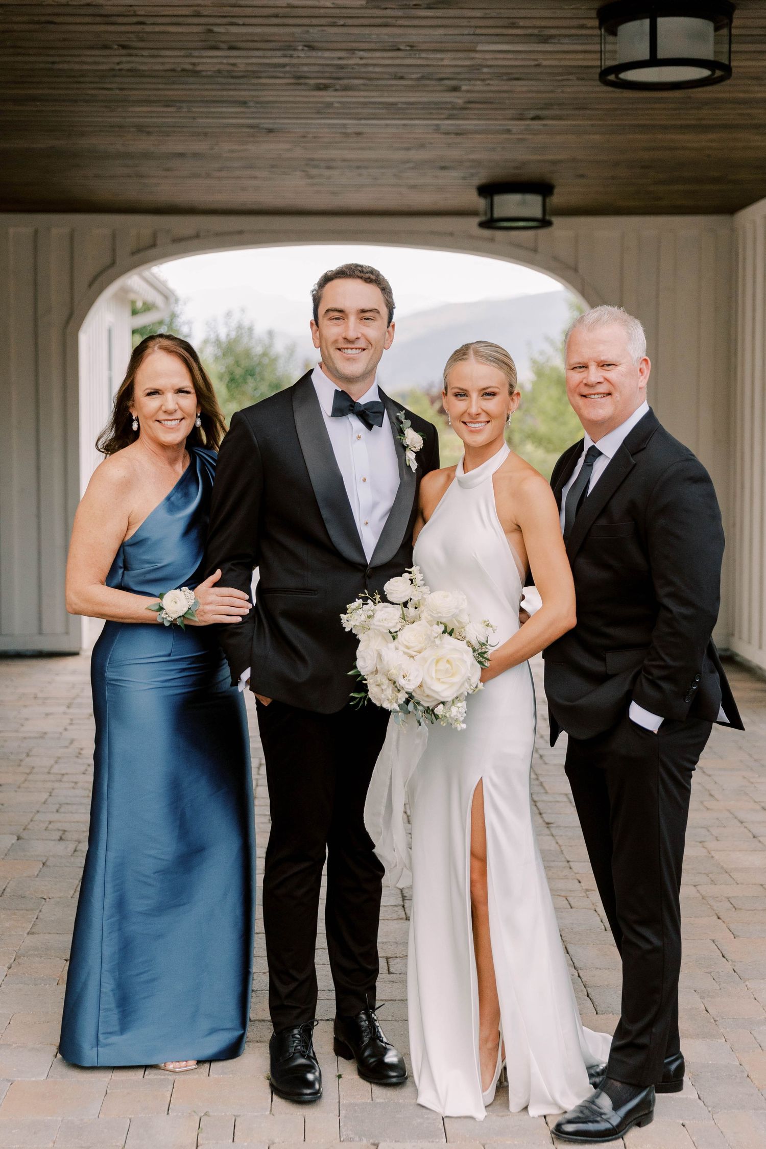 Formal family portrait under covered archway with brick floor.