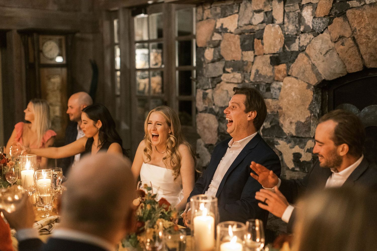 Guests enjoying a candlelit reception dinner at a rustic stone venue.
