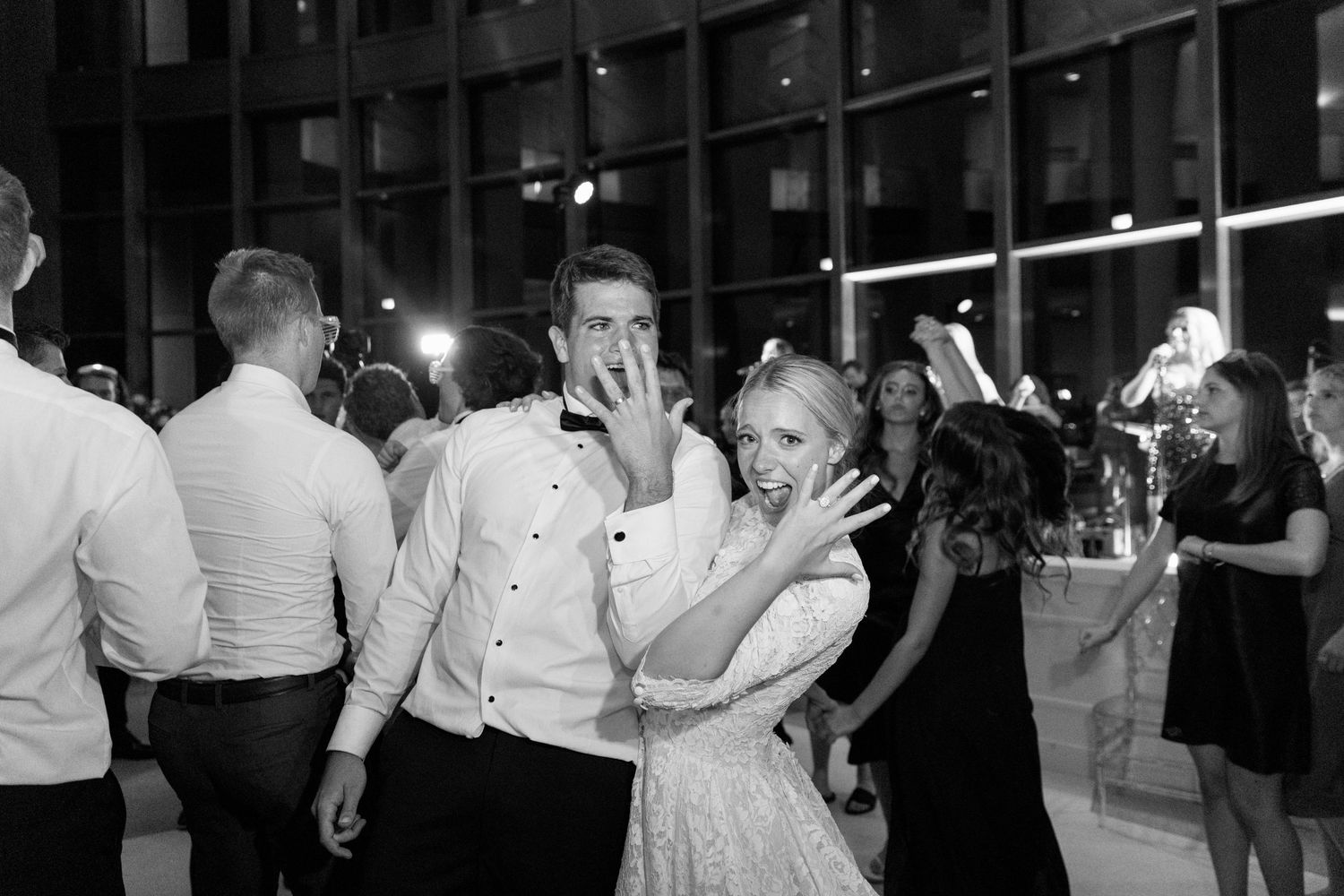 Couples dancing and celebrating at an elegant evening wedding reception.