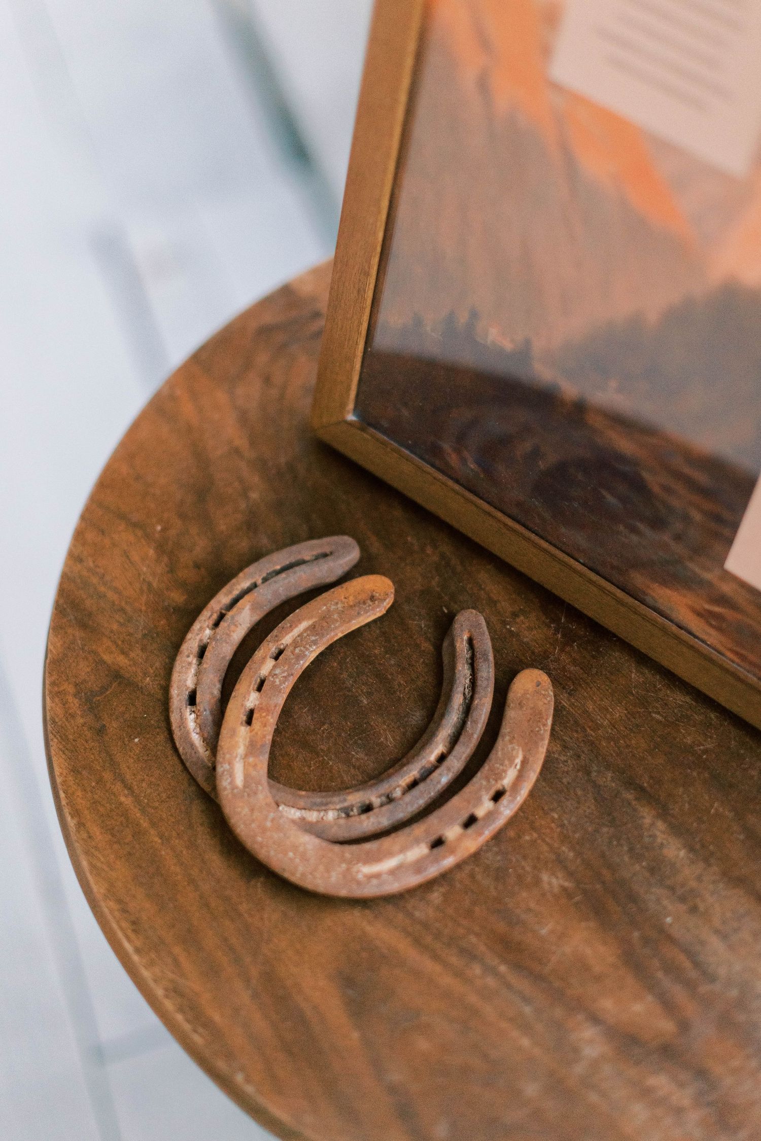 A rustic horseshoe decoration displayed on wooden surface.