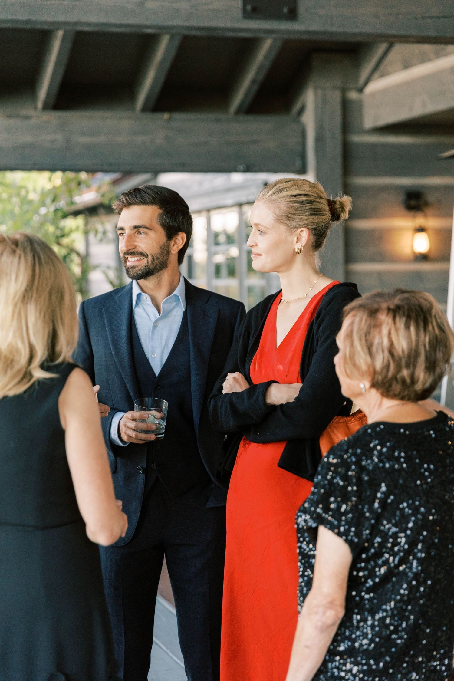 Elegant guests mingling at outdoor reception event.