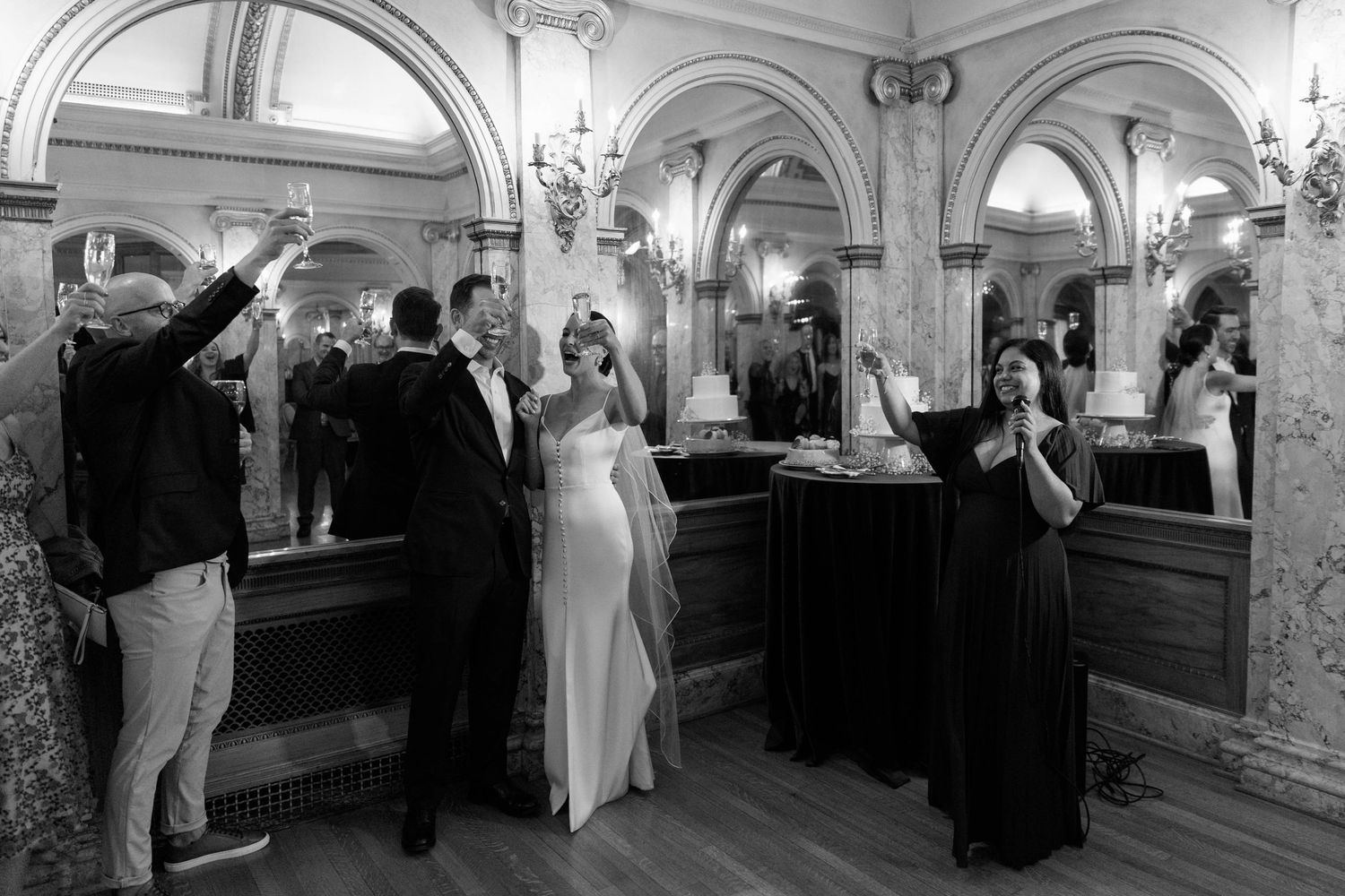 Wedding celebration in an ornate venue with arched ceilings and marble details.