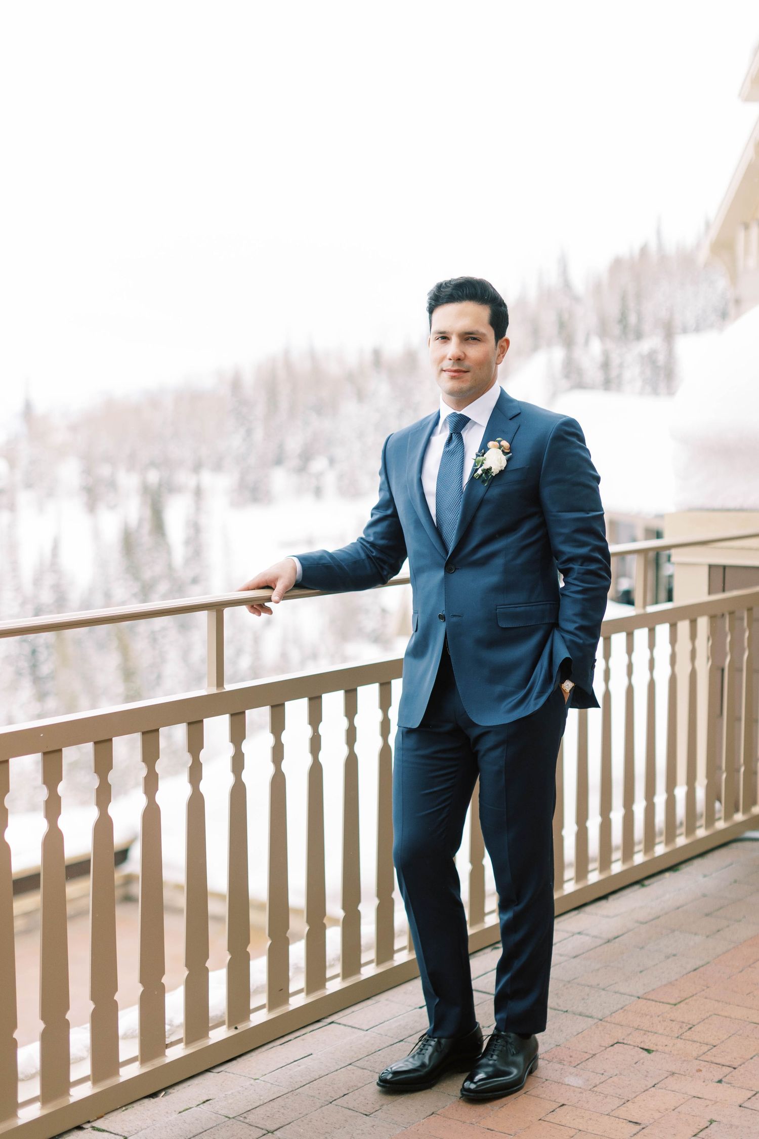 Winter mountain wedding scene with snow-covered slopes in background.