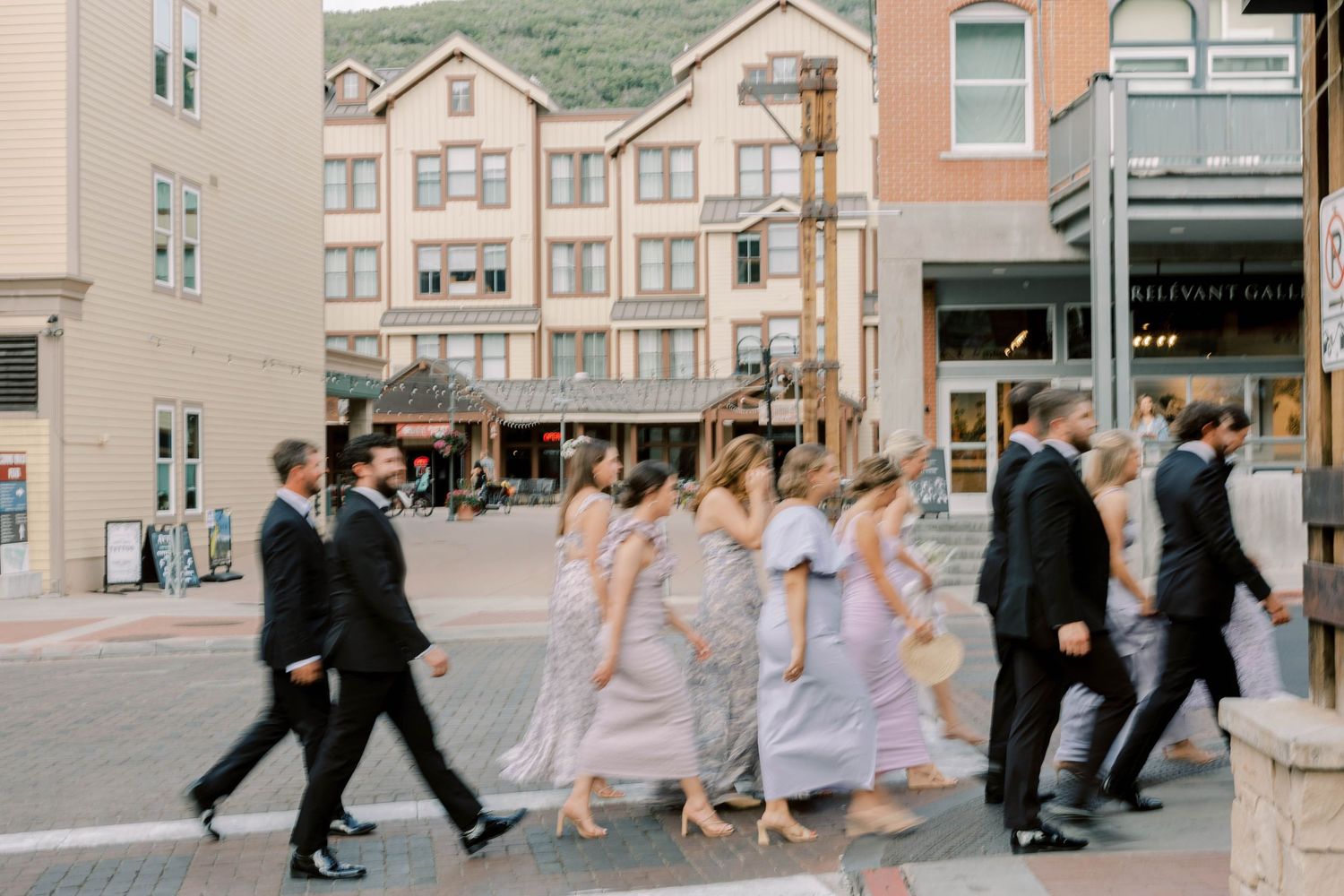 Wedding party walking through downtown streets of Park City area wearing coordinated formal attire.