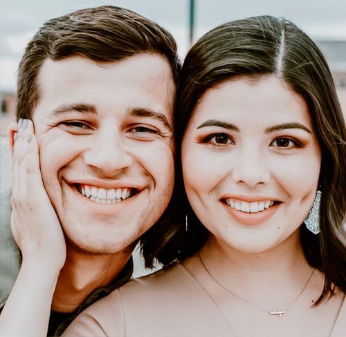 Close up portrait of smiling couple against blurred background.