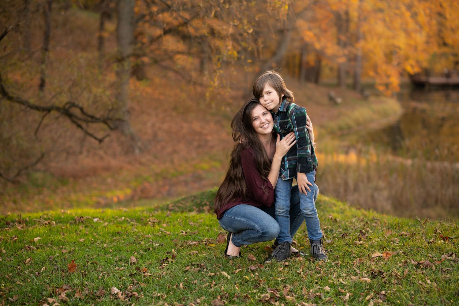 photographer Laura Priestley poses for a picture in front of a lake with one of her sons