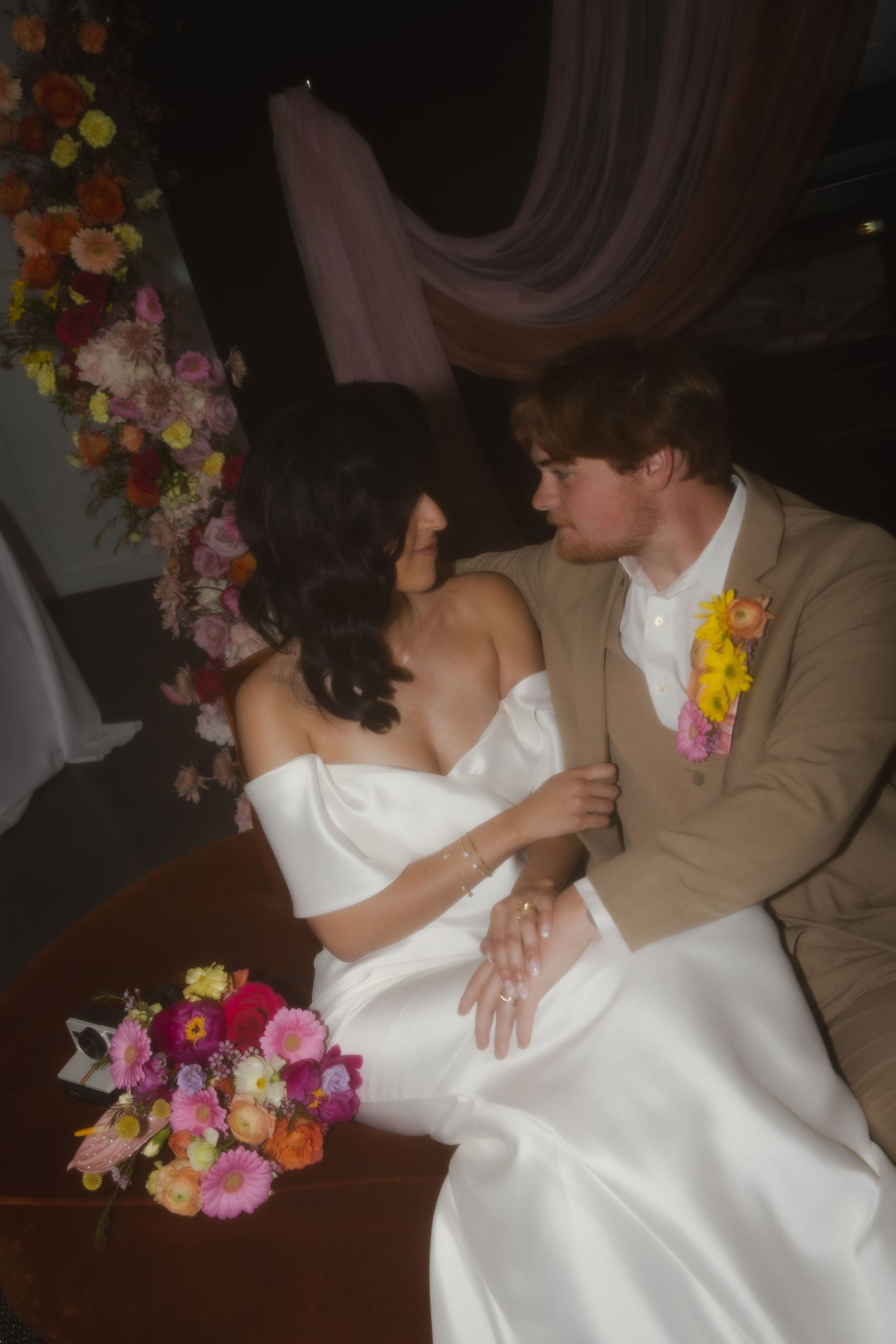 Dancing couple at their wedding reception are seen in a repeating series of romantic dance poses in warm lighting.