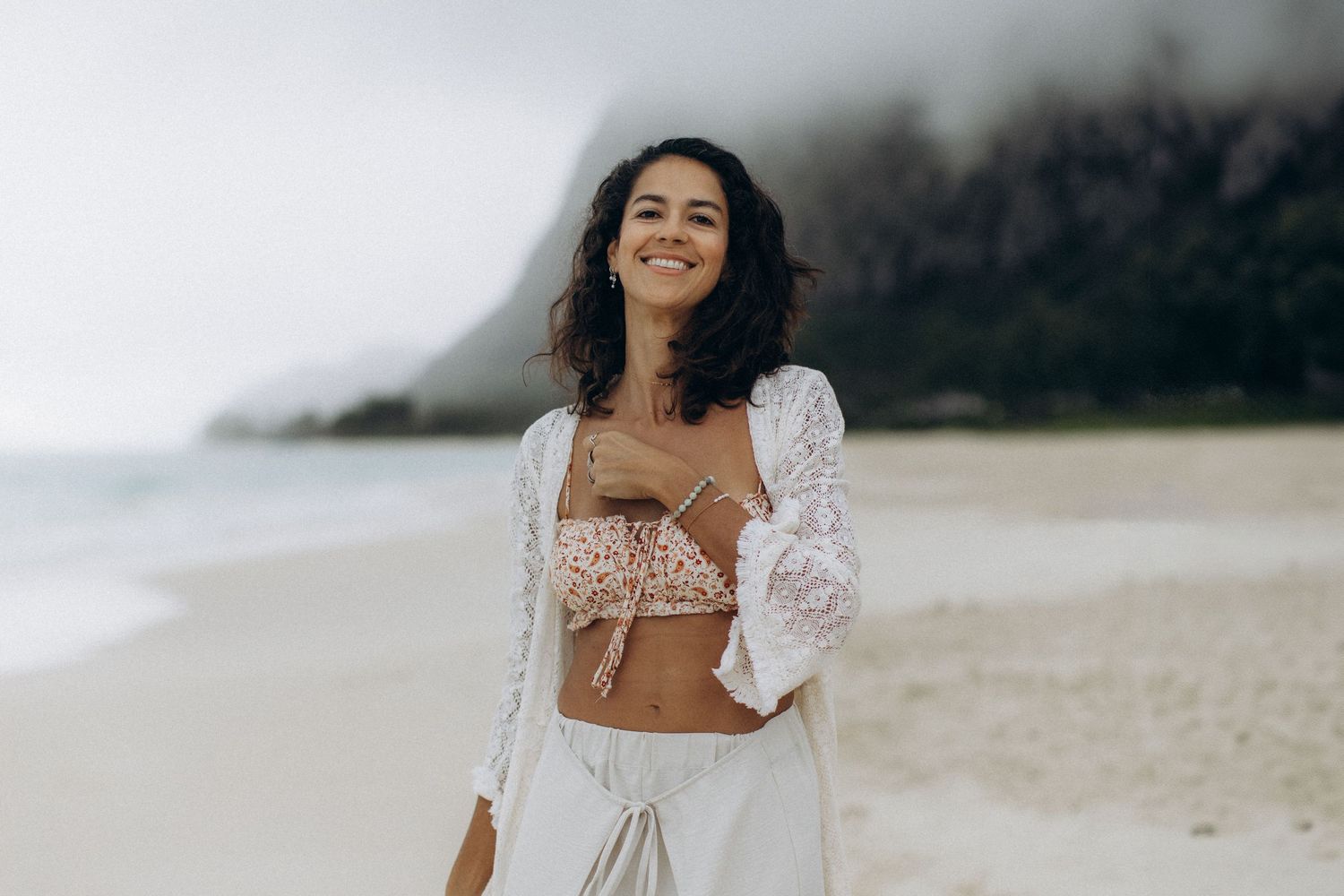 woman standing on Maui beach smiling