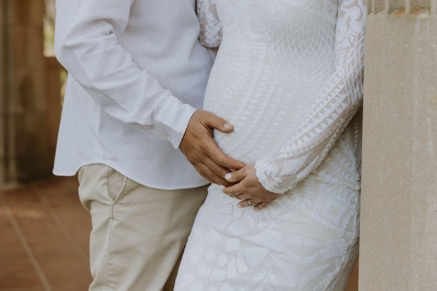 A couple in white and beige clothing embracing while softly touching a pregnant belly. Birth Photographer RI
Luxury Maternity
Fine Art Mater