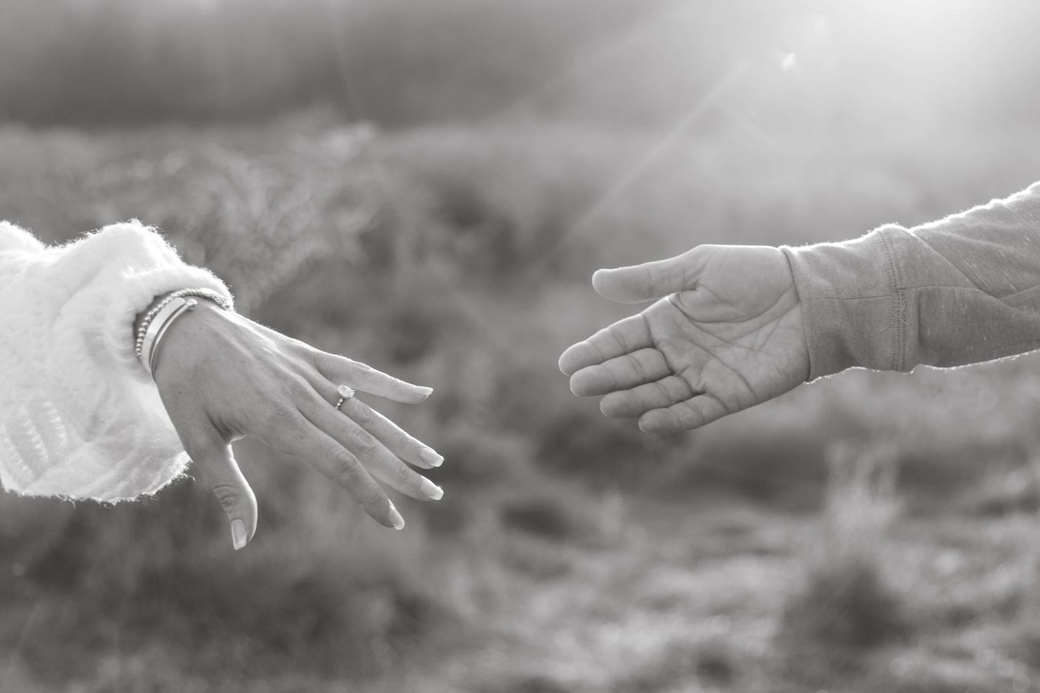 Black and white close-up image of a holding hands sequence showing progression of different hand positions.