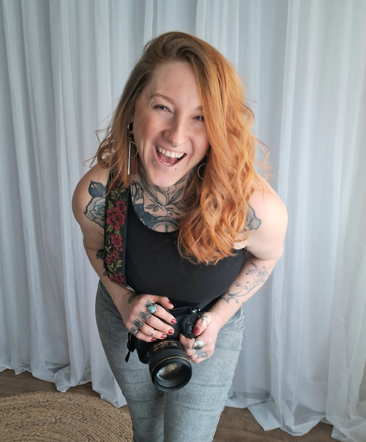 Chris from C M Photography laughing whilst holding her camera. Photographer from Harrogate, North Yorkshire.
