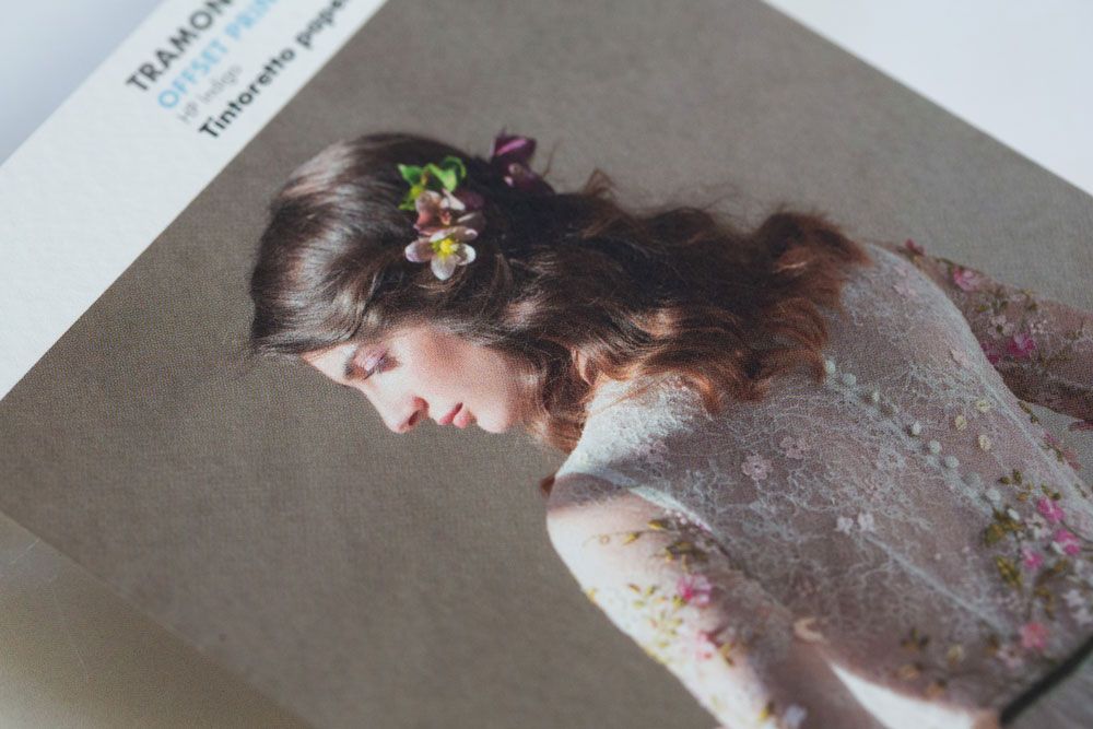 A delicate floral portrait showcasing a woman in a flowing dress surrounded by blooming spring flowers.