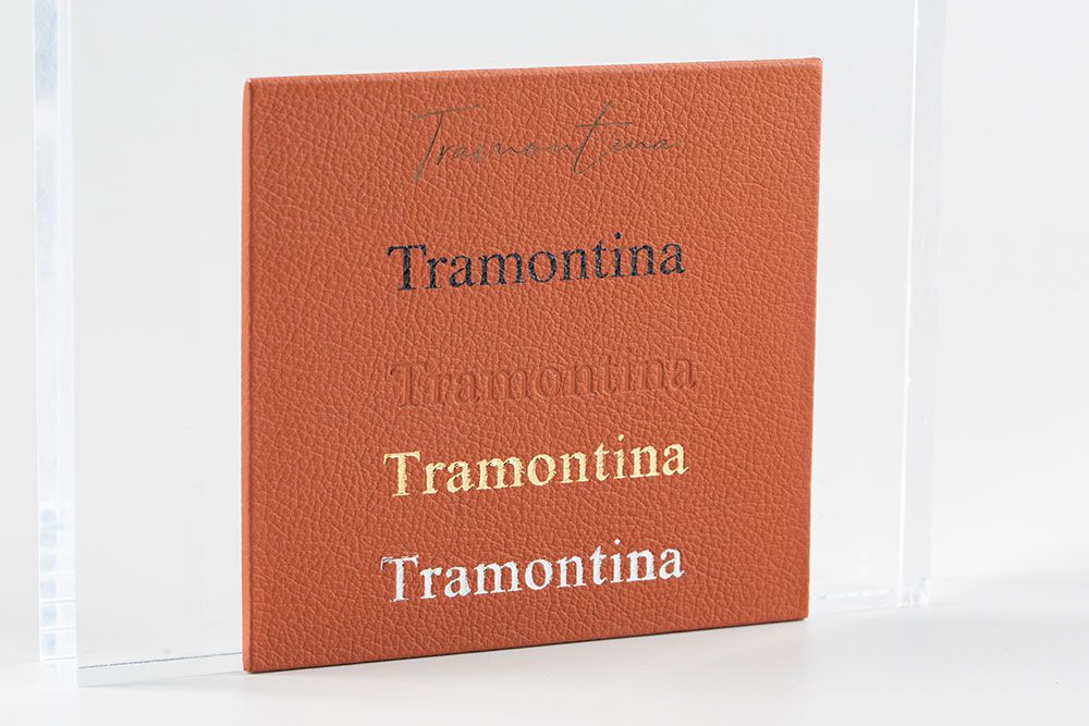 Six burnt orange Tramontina branded boxes arranged in a row against a white background show a premium product display.
