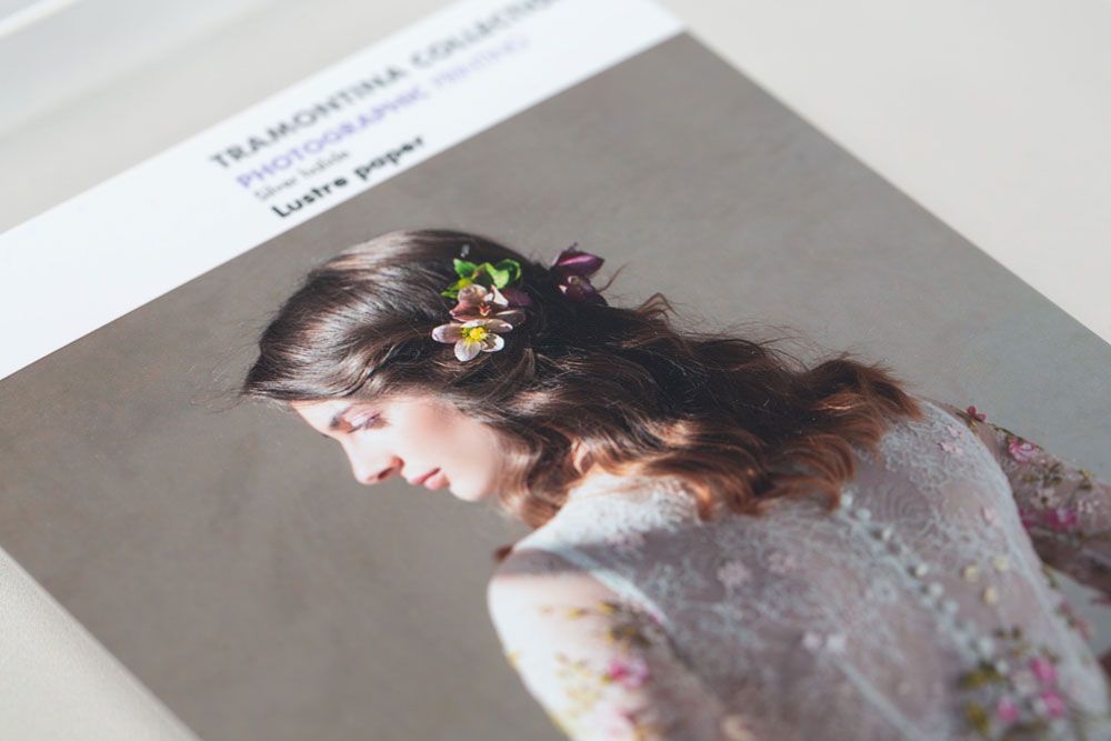 A side profile view of a person adorned with delicate floral hair accessories and wearing a soft textured garment.